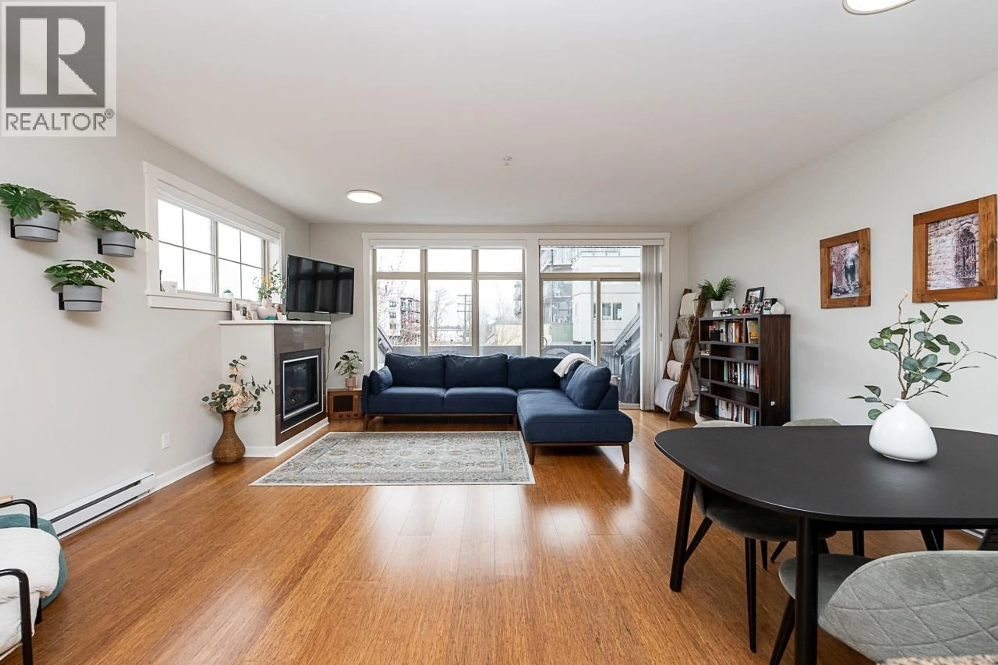 Living room with furniture, wood/laminate floor for 220 - 6111 LONDON ROAD, Richmond British Columbia V7E3S3