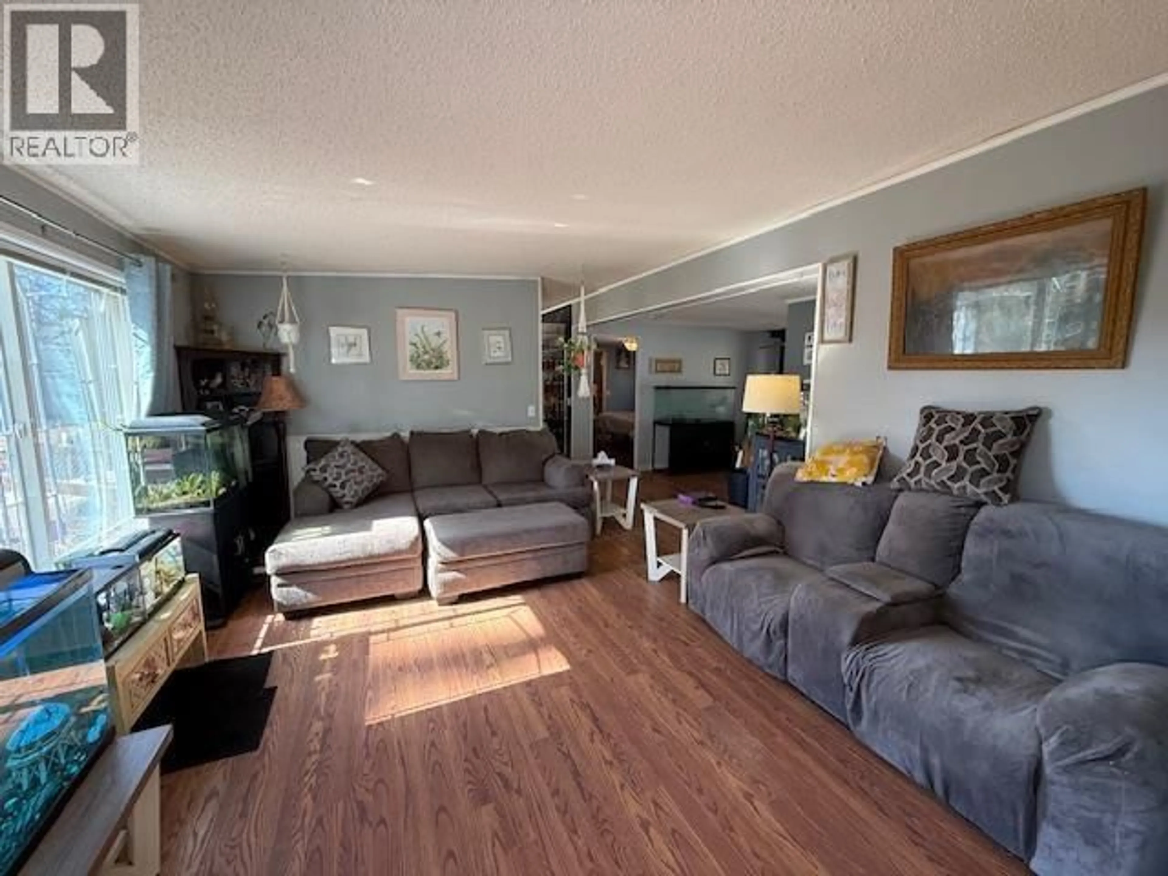 Living room with furniture, wood/laminate floor for 11834 WATSON PLACE, Topley British Columbia V0J2Y0