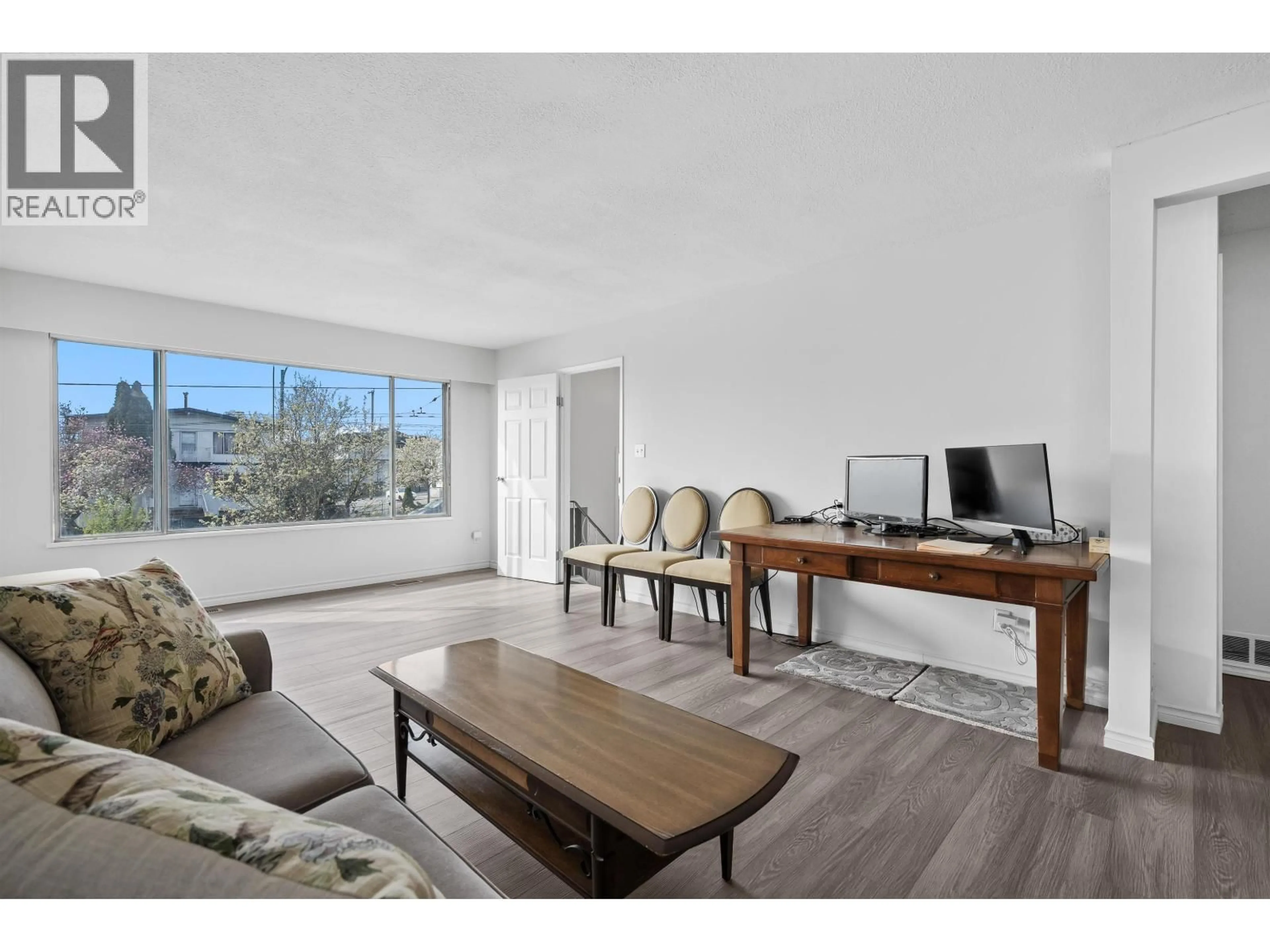 Living room with furniture, wood/laminate floor for 7656 MAIN STREET, Vancouver British Columbia V5X3K3