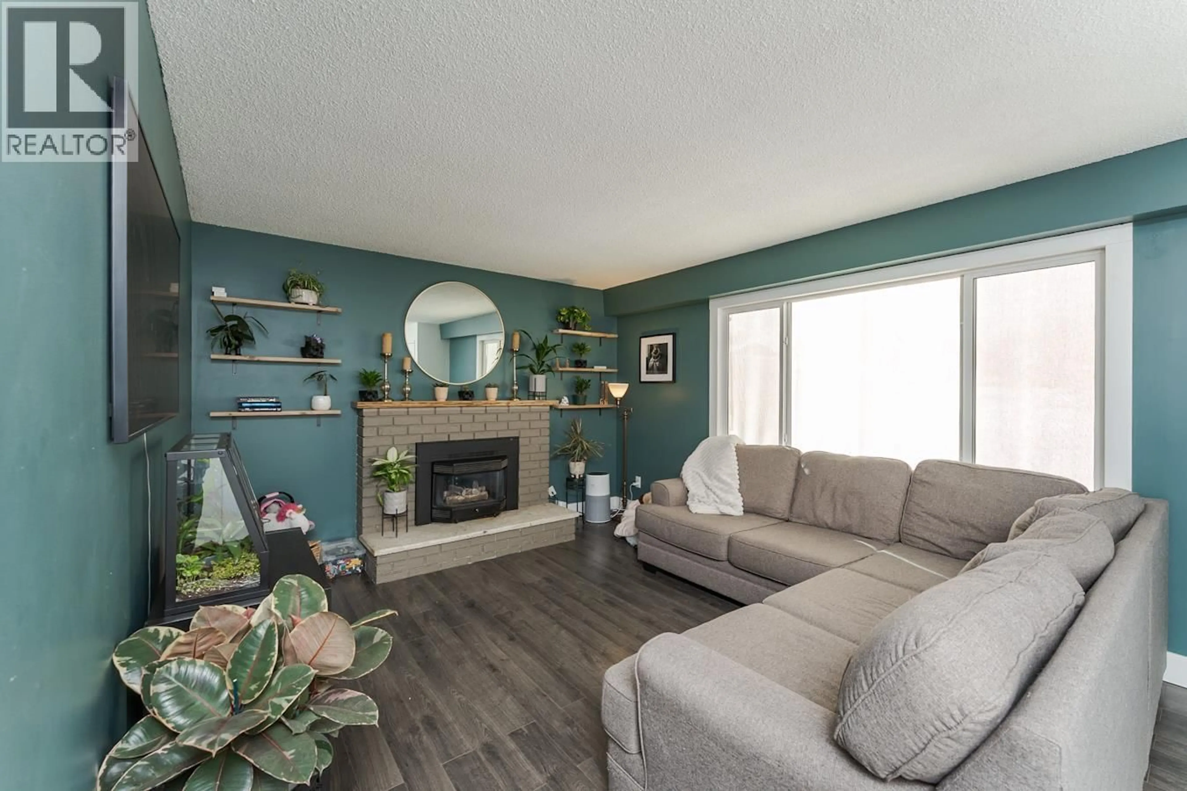 Living room with furniture, wood/laminate floor for 7104 HARTFORD CRESCENT, Prince George British Columbia V2N0A8