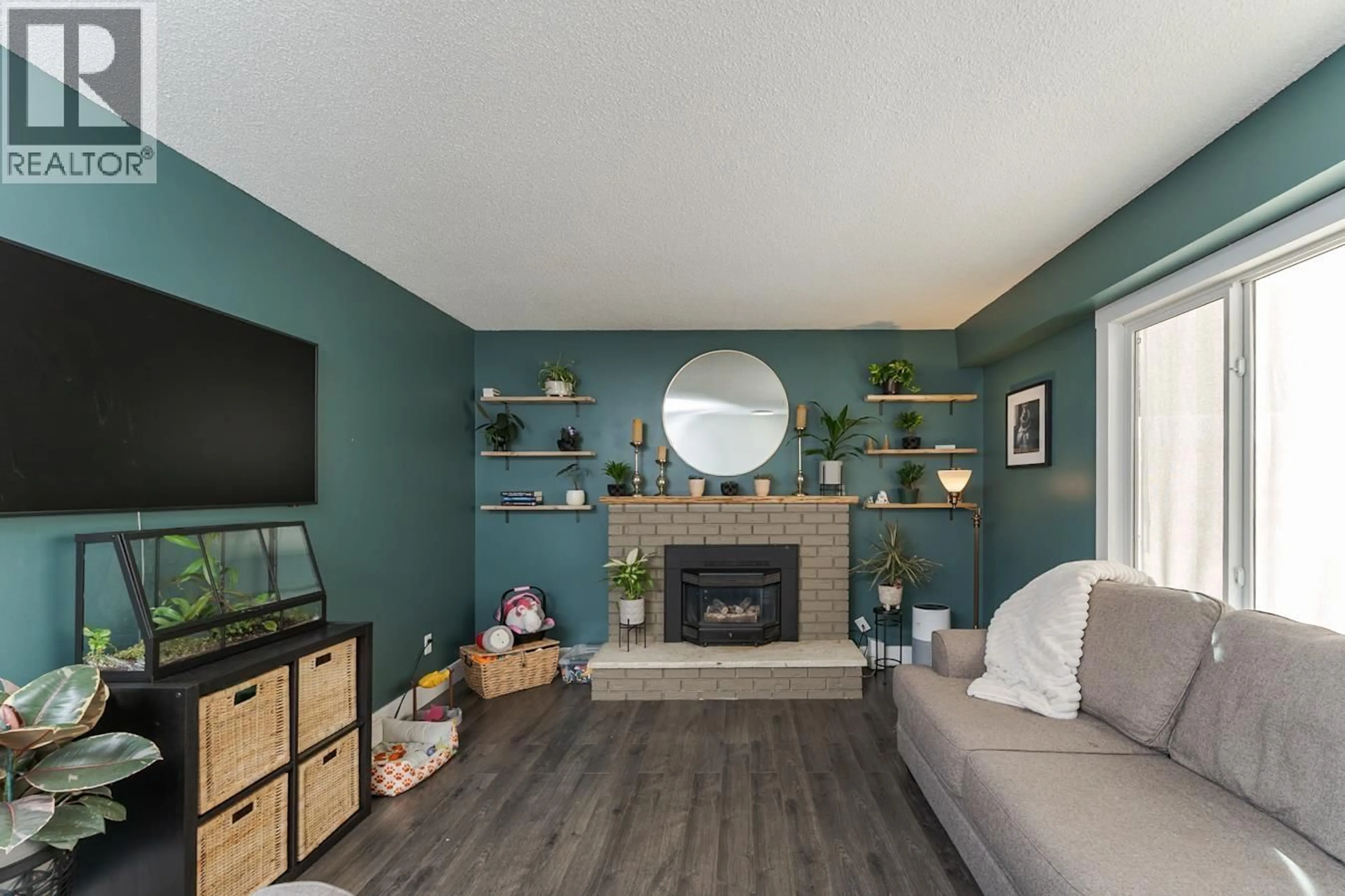 Living room with furniture, wood/laminate floor for 7104 HARTFORD CRESCENT, Prince George British Columbia V2N0A8