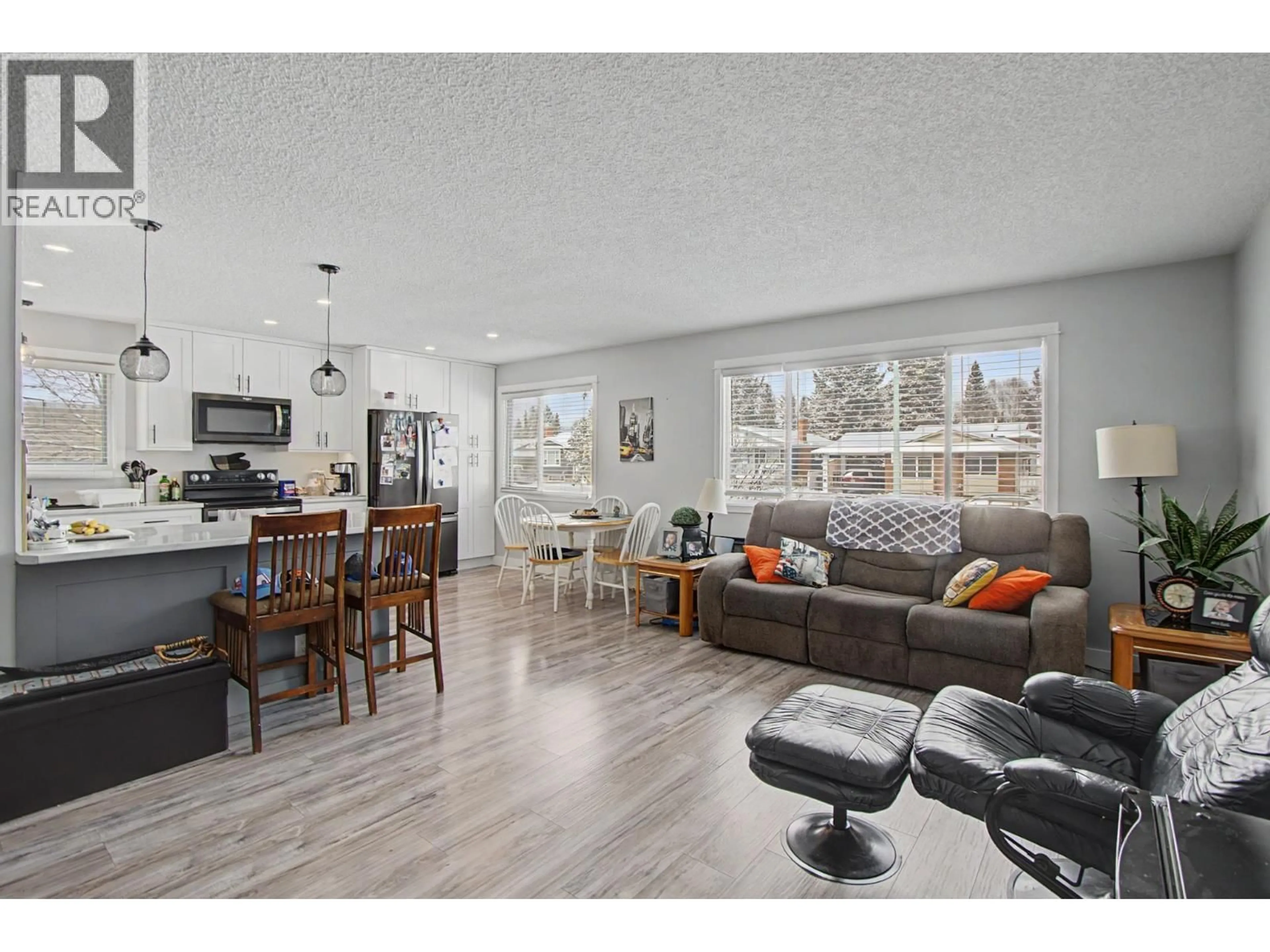 Open concept kitchen, wood/laminate floor for 7741 LANCASTER CRESCENT, Prince George British Columbia V2N3R2