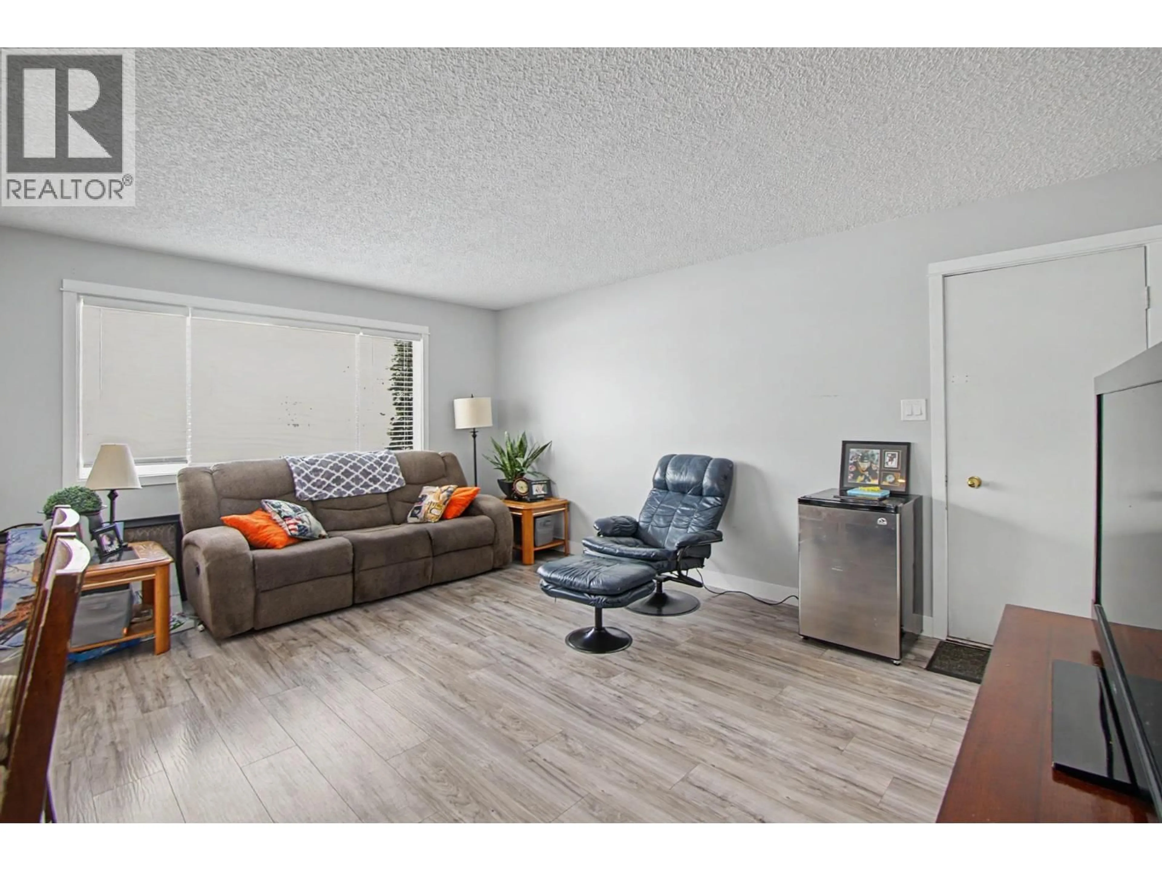 Living room with furniture, wood/laminate floor for 7741 LANCASTER CRESCENT, Prince George British Columbia V2N3R2