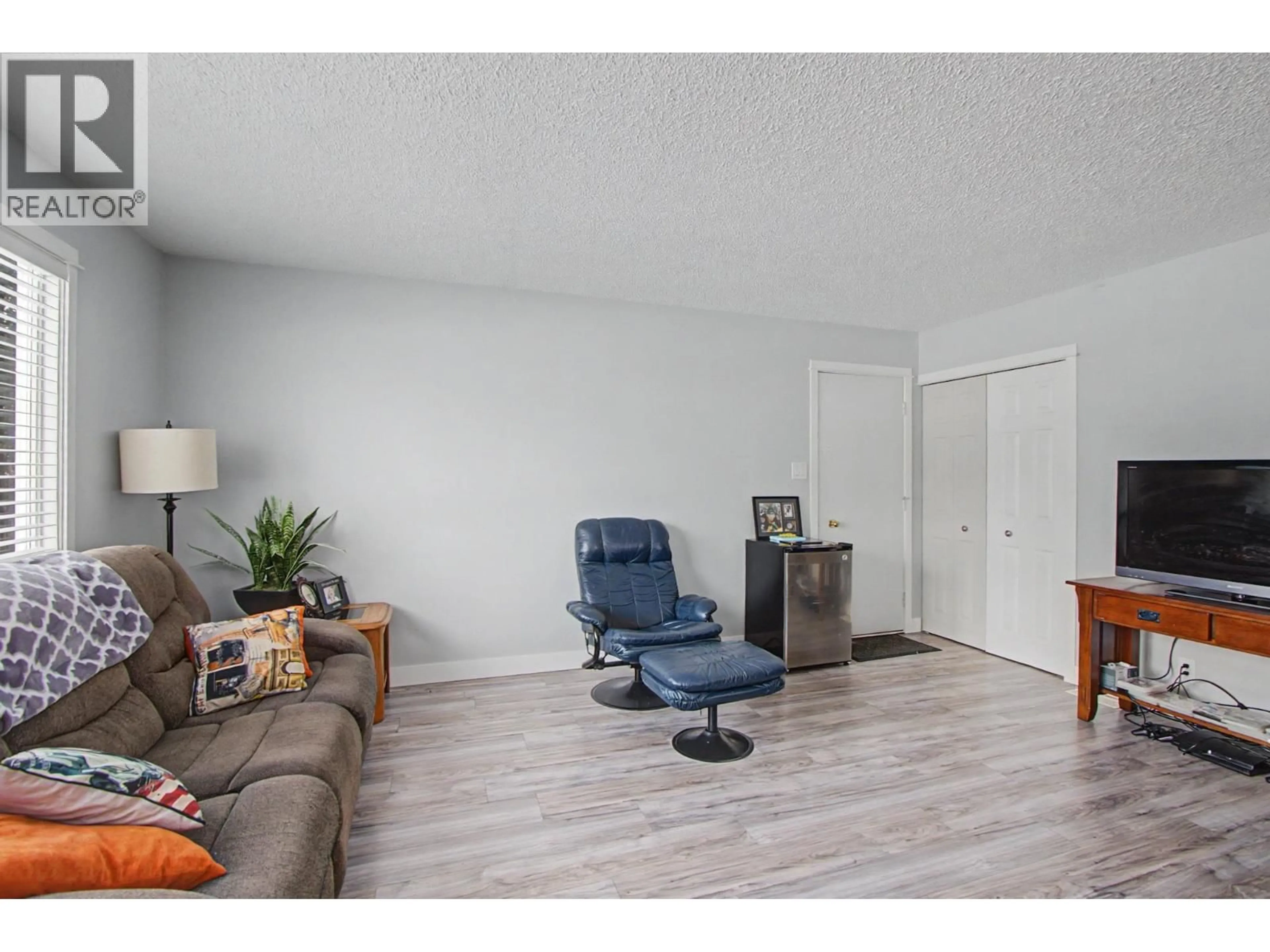 Living room with furniture, wood/laminate floor for 7741 LANCASTER CRESCENT, Prince George British Columbia V2N3R2