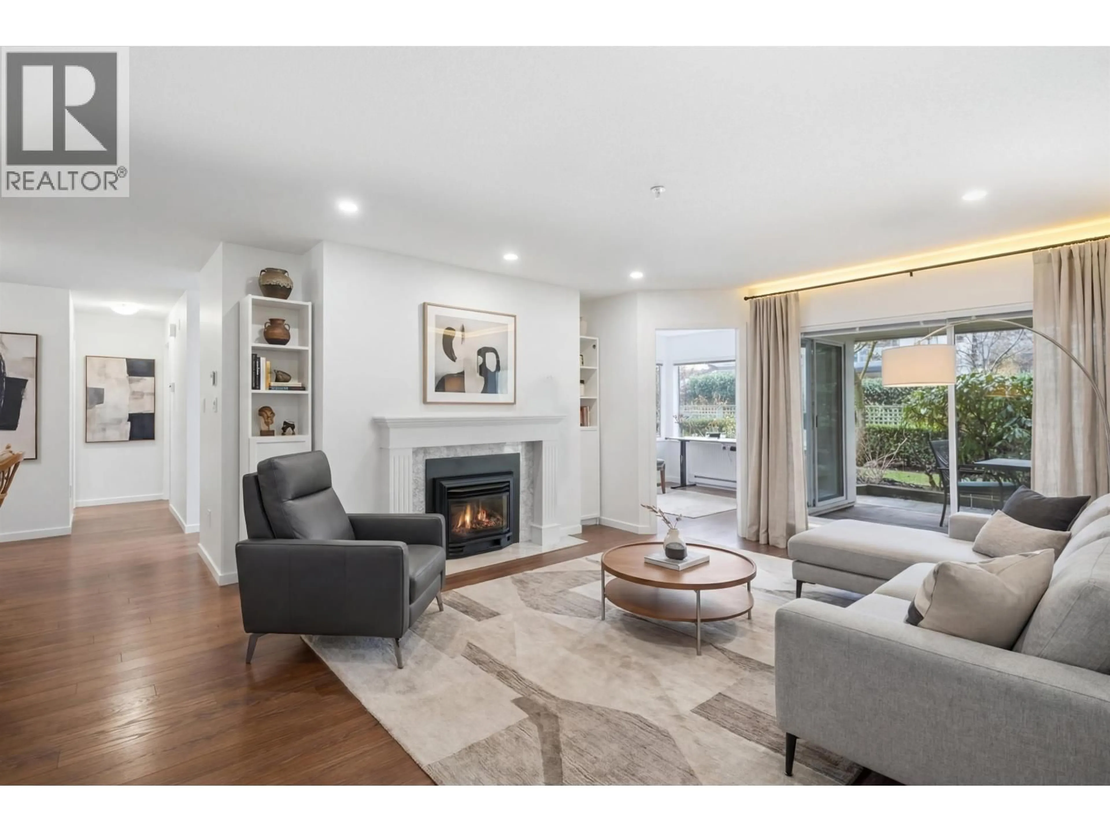 Living room with furniture, wood/laminate floor for 106 - 3670 BANFF COURT, North Vancouver British Columbia V7H2Y7