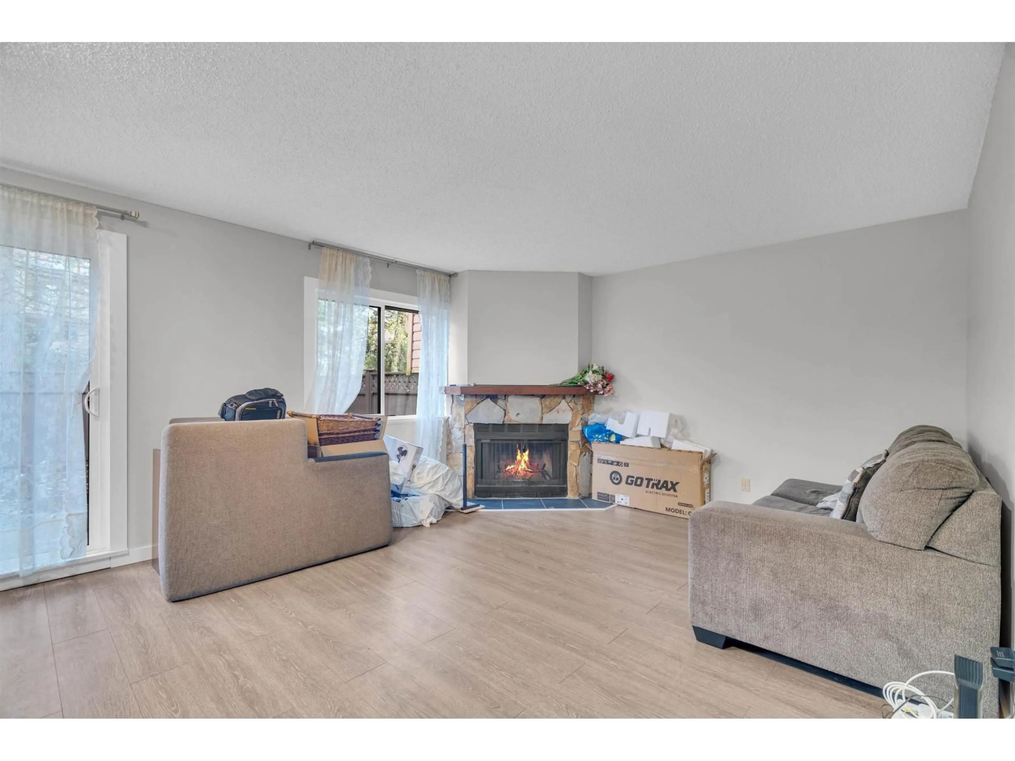 Living room with furniture, wood/laminate floor for 13335 70B AVENUE, Surrey British Columbia V3W7Z3