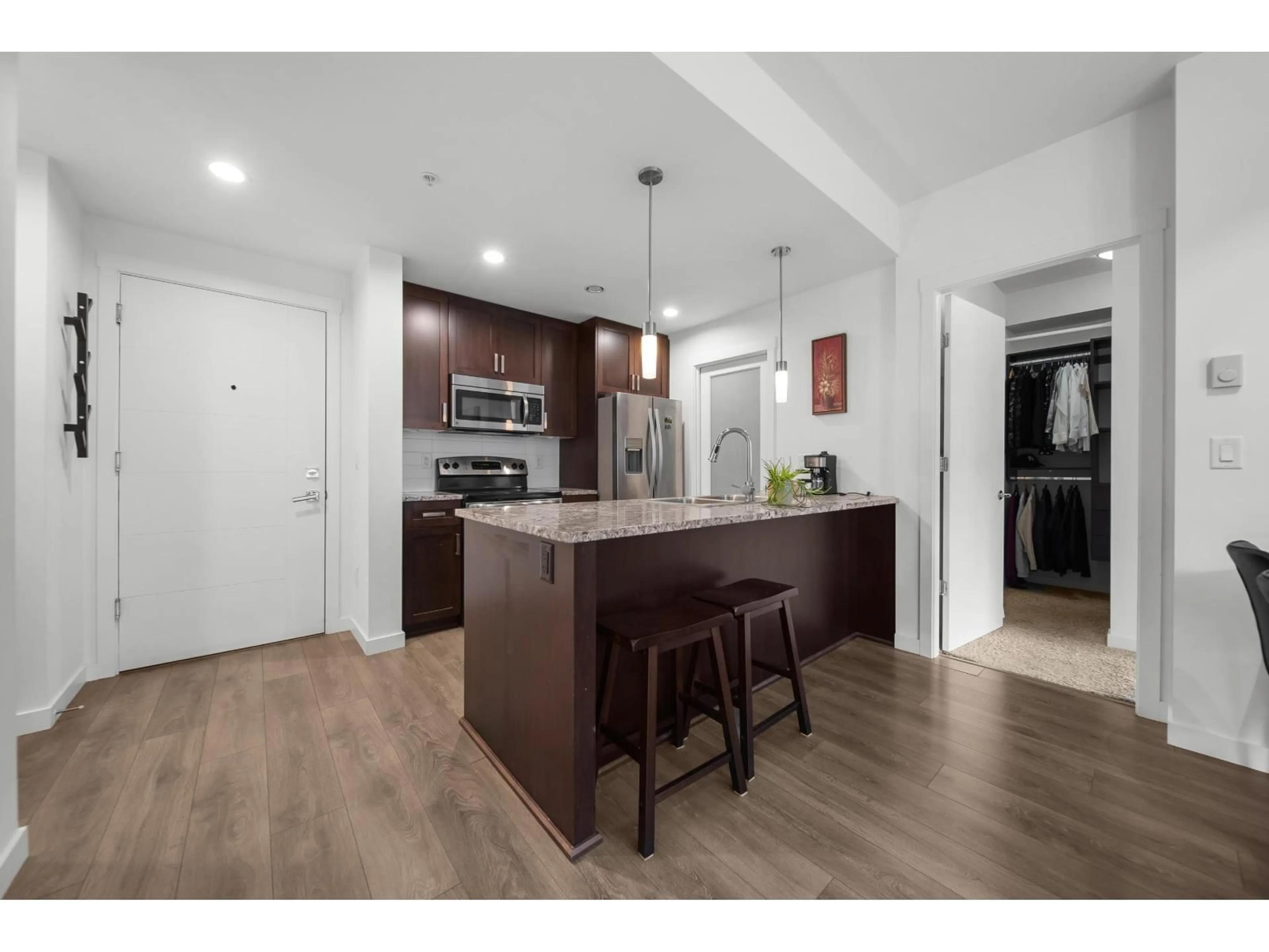 Open concept kitchen, wood/laminate floor for 204 - 2238 WHATCOM ROAD, Abbotsford British Columbia V3G0E6