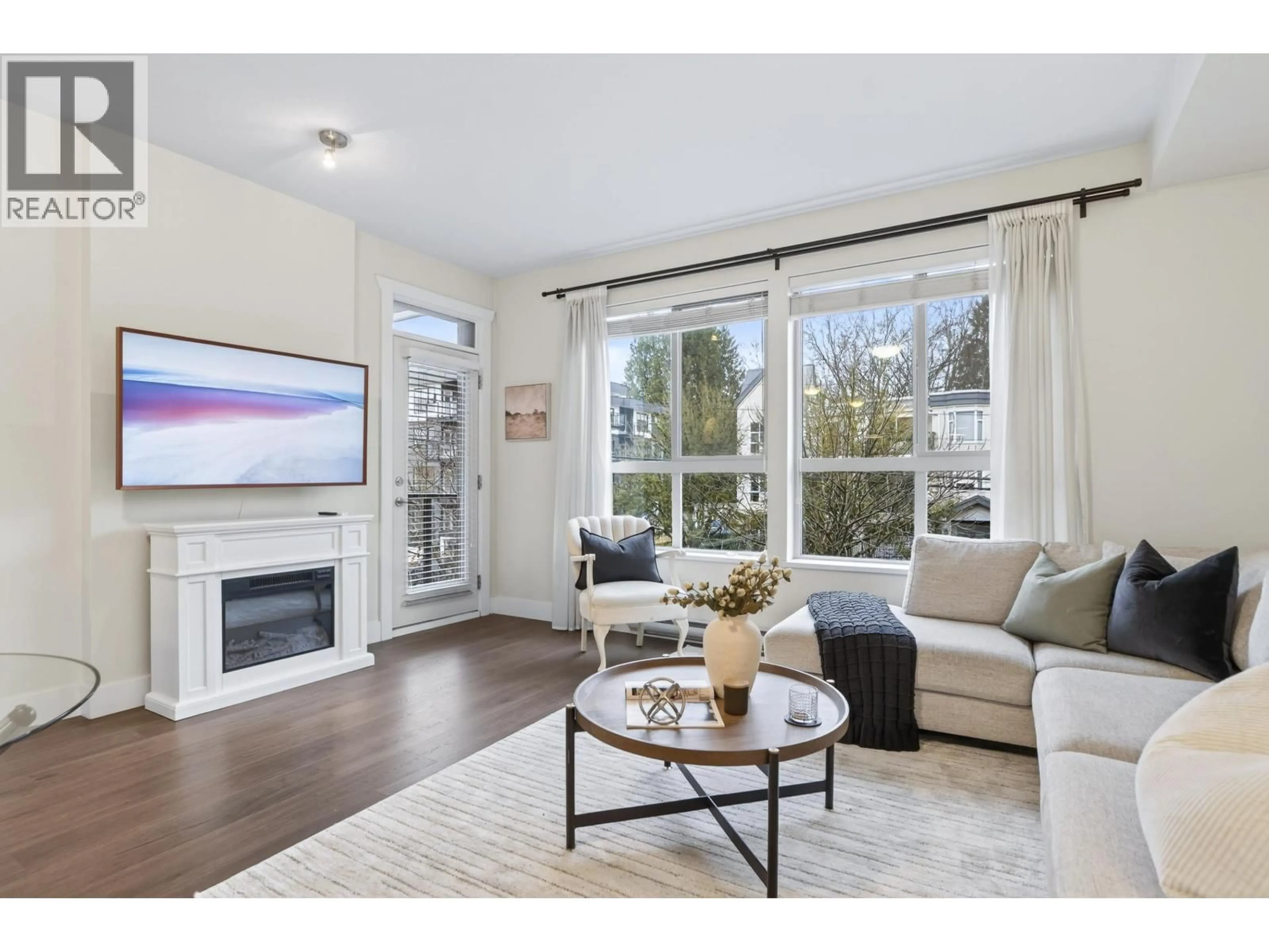 Living room with furniture, wood/laminate floor for 202 - 2288 WELCHER AVENUE, Port Coquitlam British Columbia V3C1X3