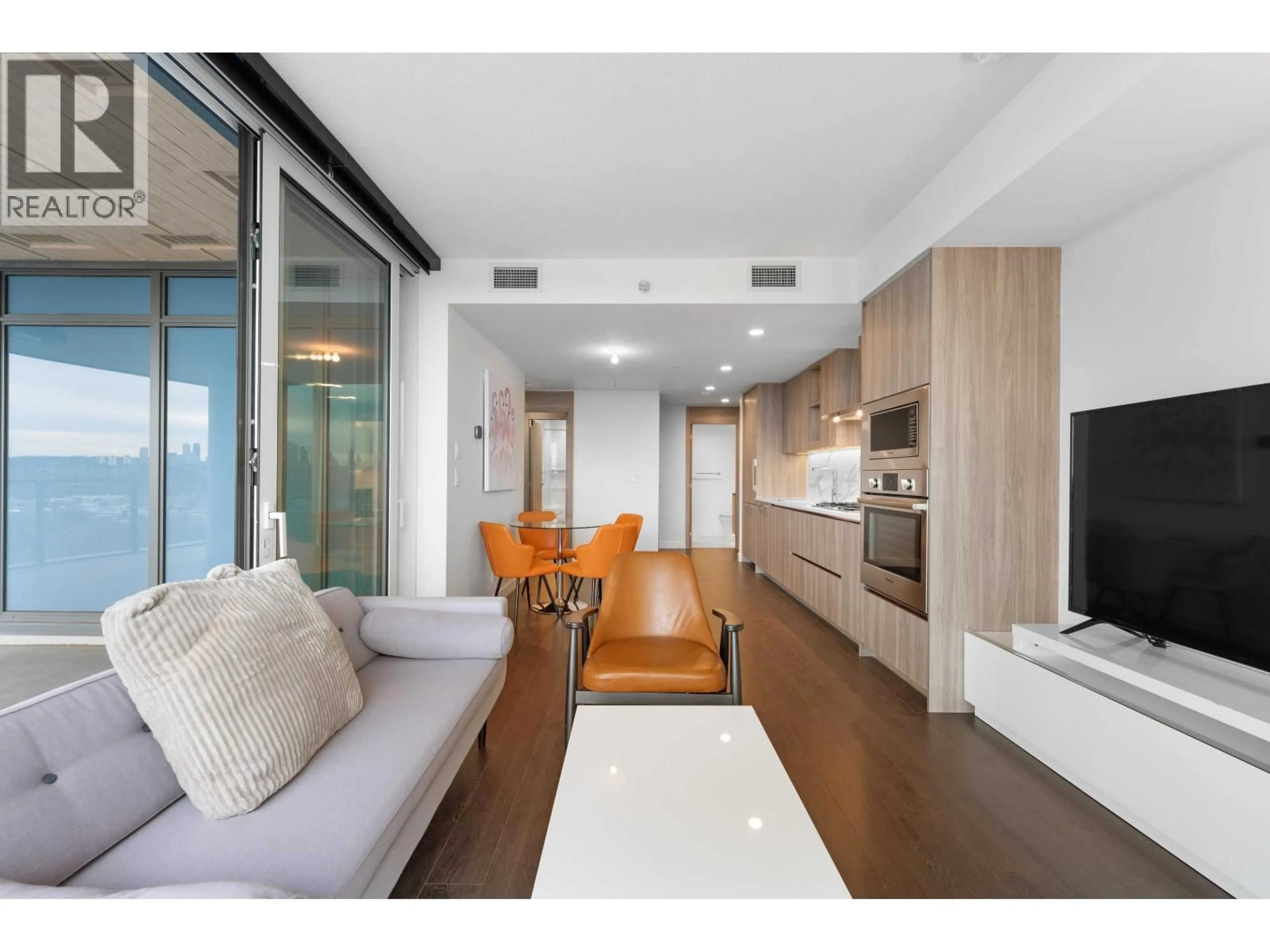 Living room with furniture, wood/laminate floor for 2402 - 4890 LOUGHEED HIGHWAY, Burnaby British Columbia V5C0N1