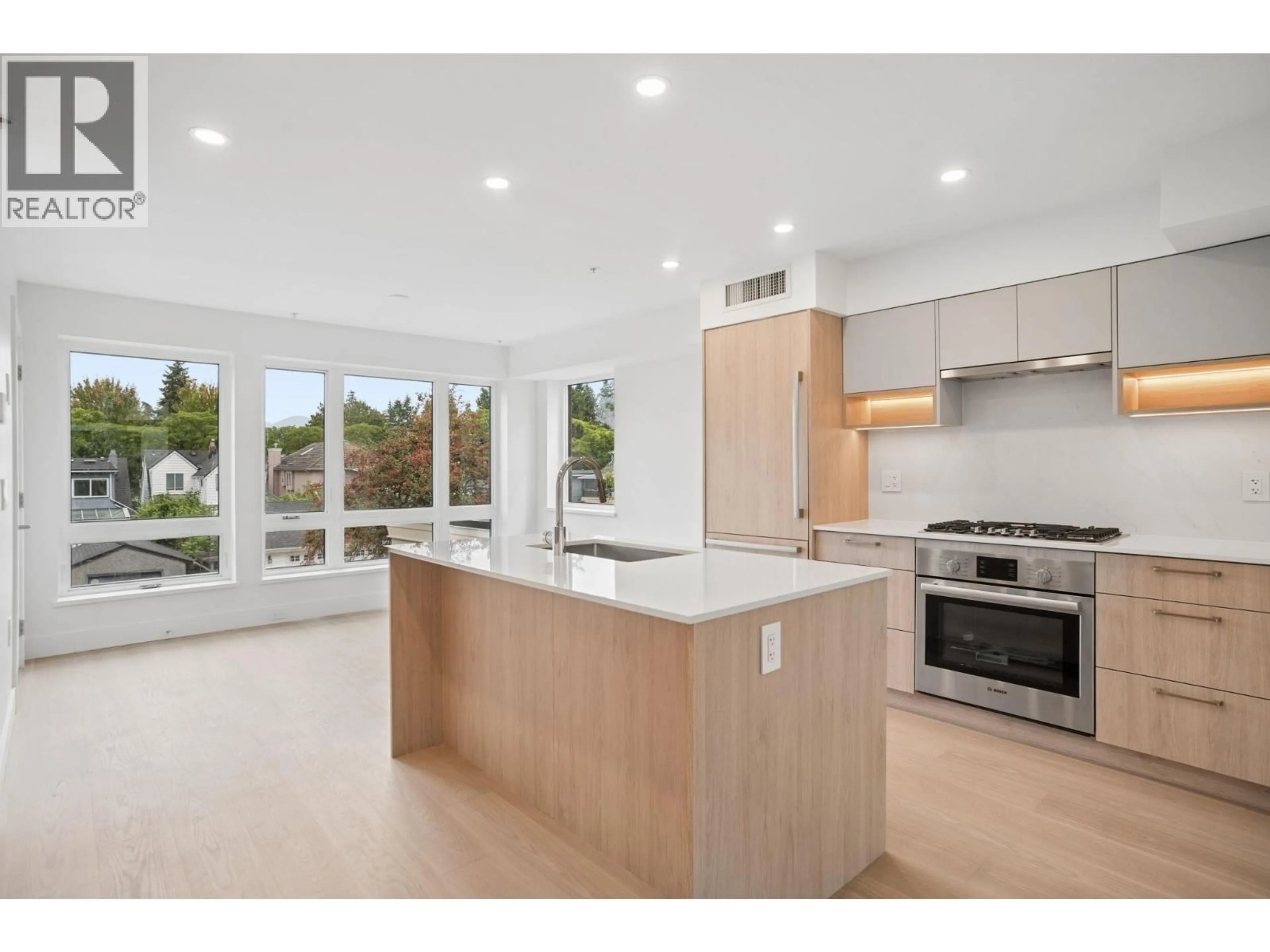 Open concept kitchen, wood/laminate floor for 202 - 578 24 AVENUE, Vancouver British Columbia V5Z2B4