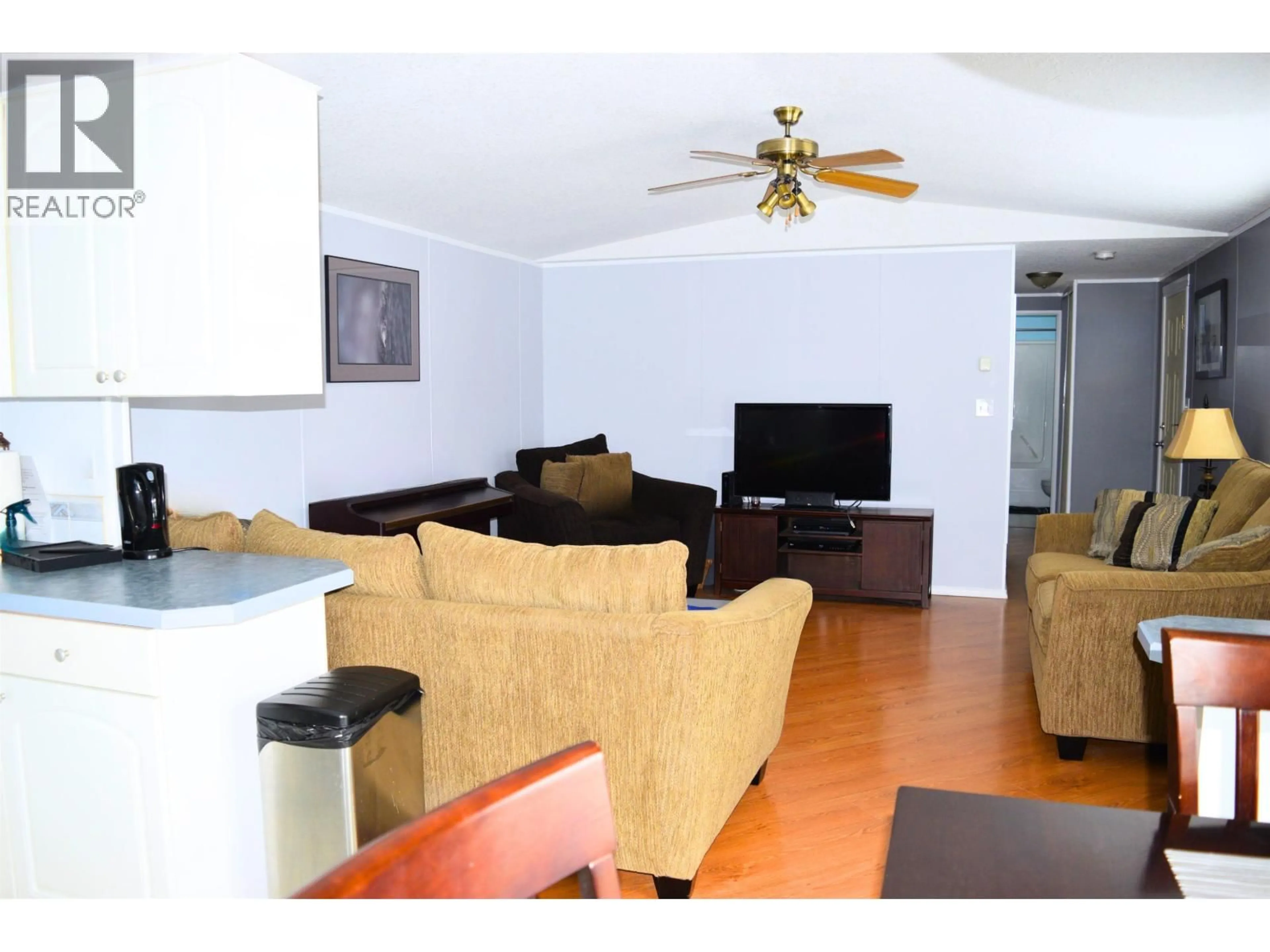 Living room with furniture, wood/laminate floor for 10679 102 STREET, Taylor British Columbia V0C2K0