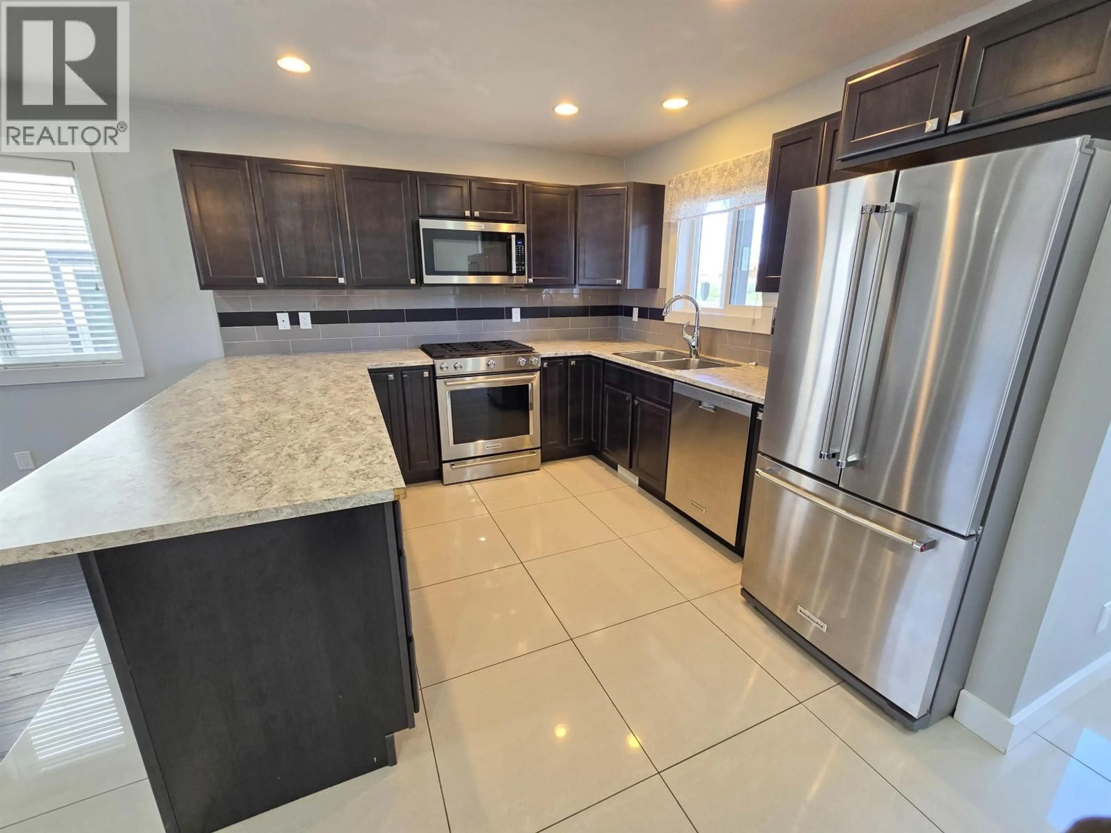 Open concept kitchen, ceramic/tile floor for 8617 74 STREET, Fort St. John British Columbia V1J2Y5