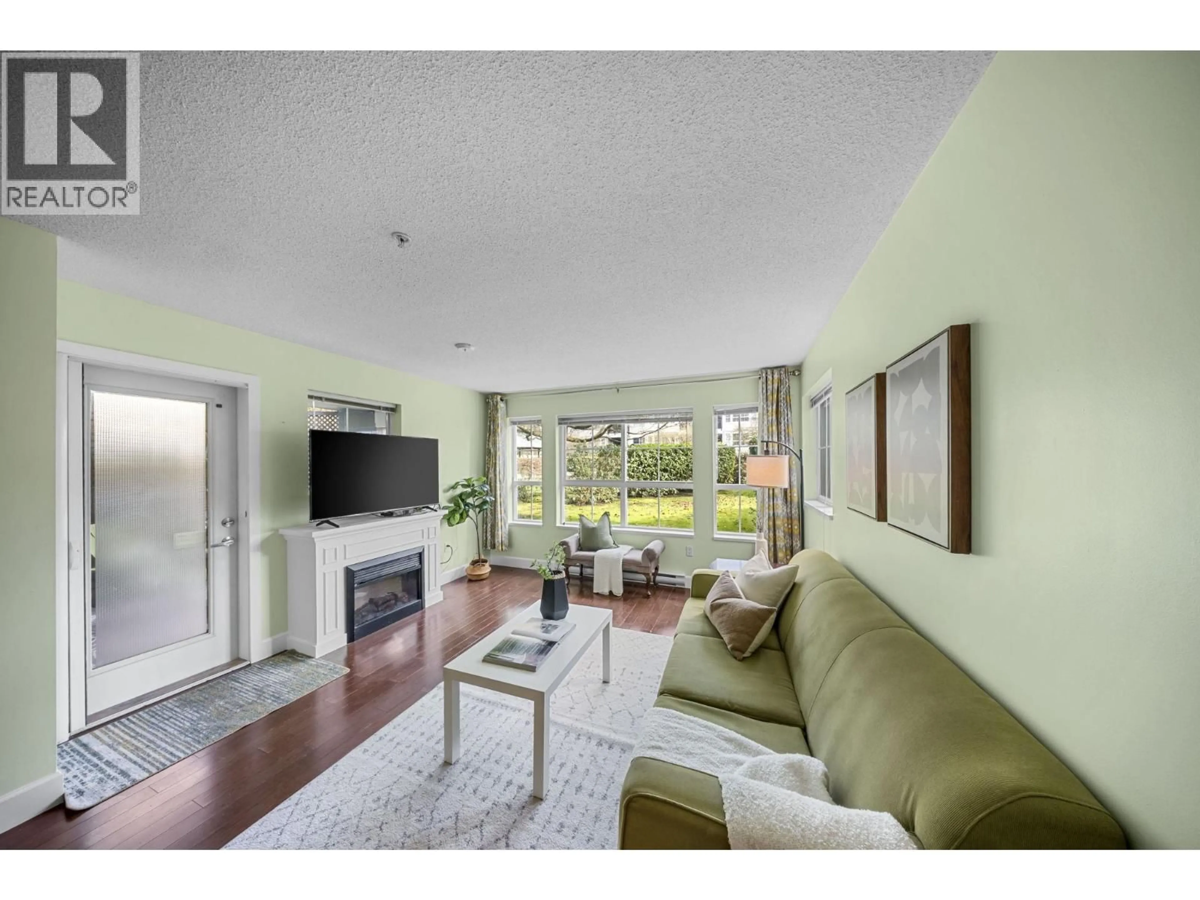 Living room with furniture, wood/laminate floor for 120 - 19677 MEADOW GARDENS WAY, Pitt Meadows British Columbia V3Y0A2