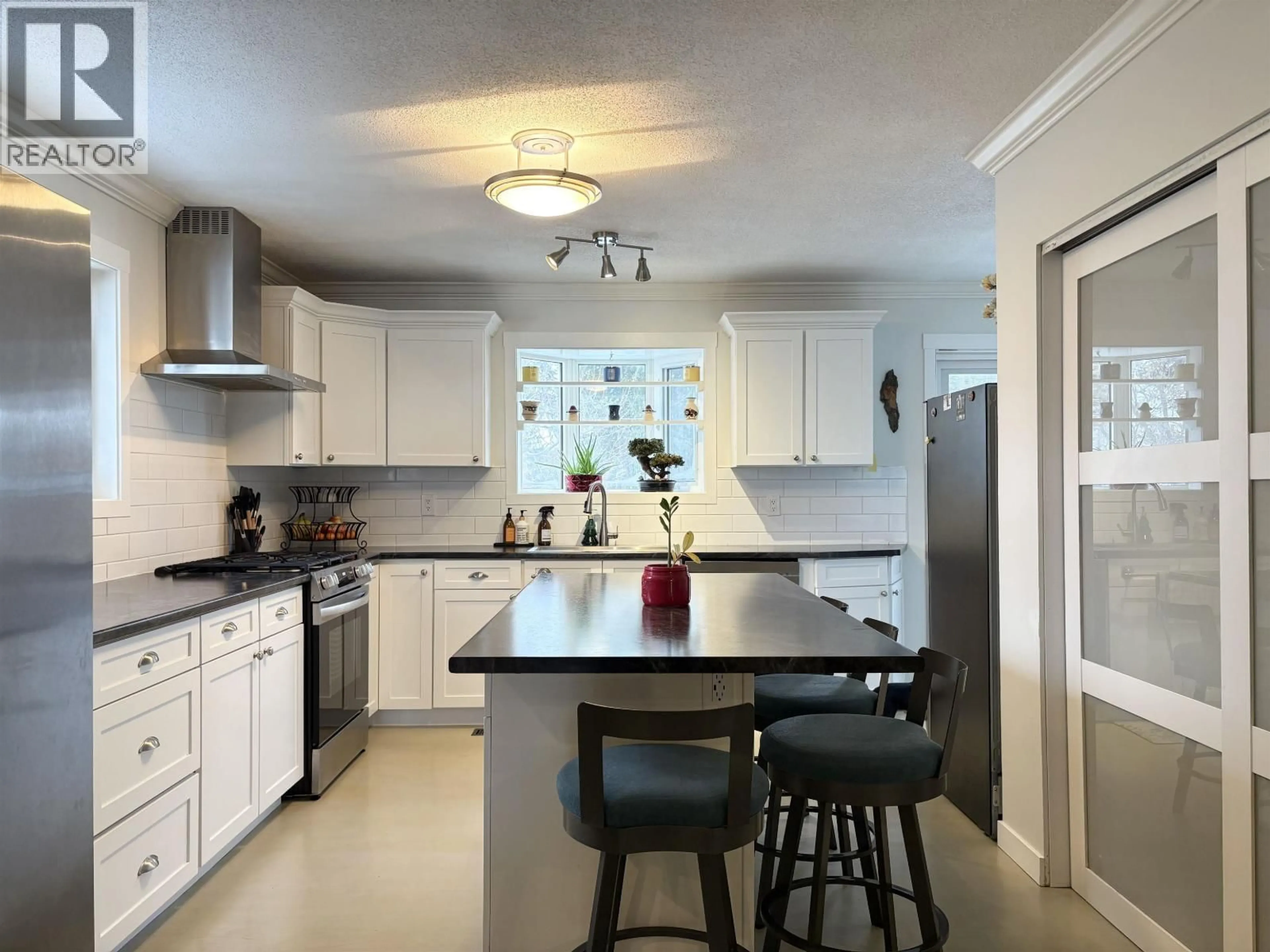 Open concept kitchen, ceramic/tile floor for 7709 LEMOYNE PLACE, Prince George British Columbia V2N3N2