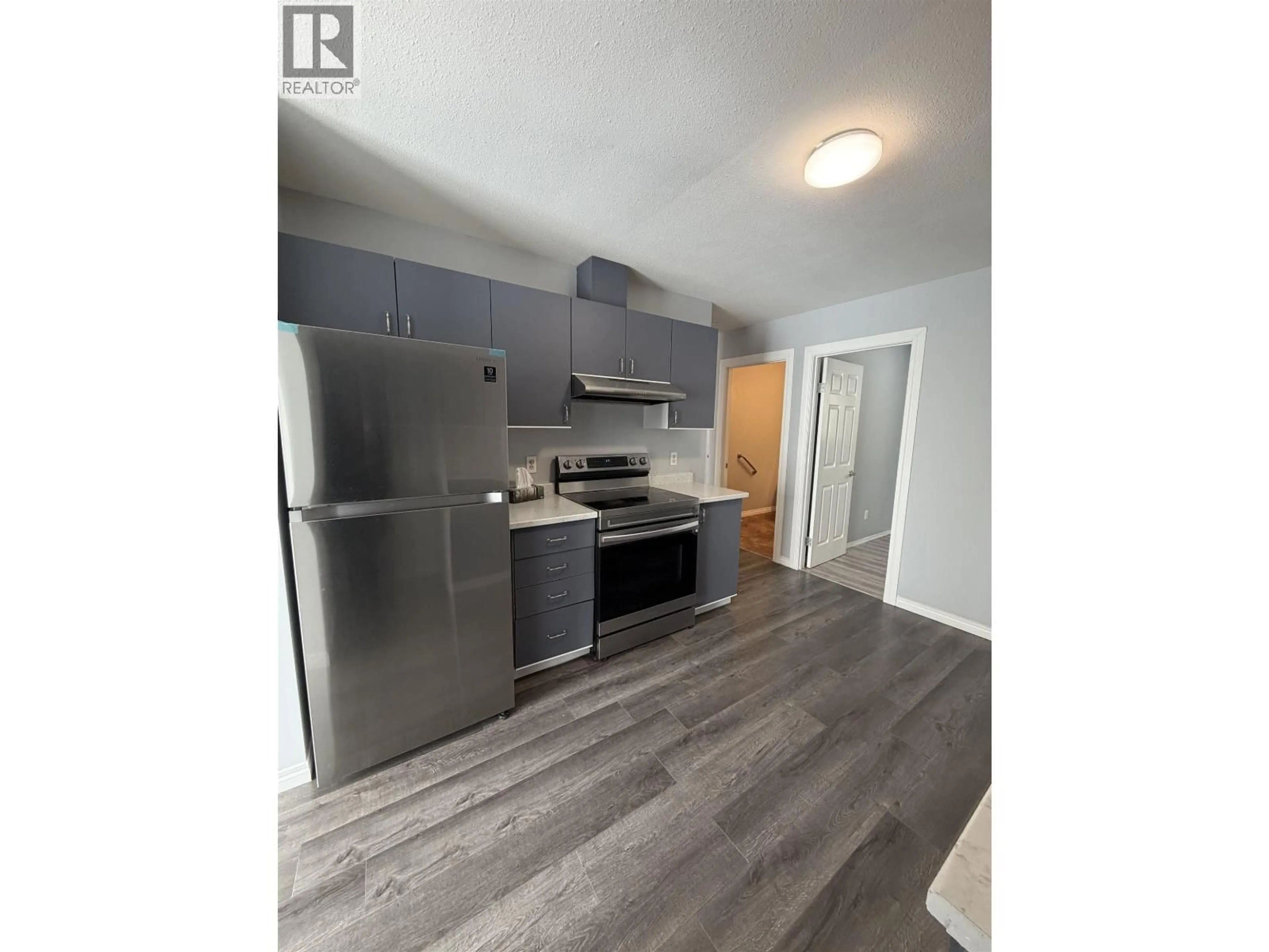 Open concept kitchen, wood/laminate floor for 104 - 9019 86 STREET, Fort St. John British Columbia V1J6X4