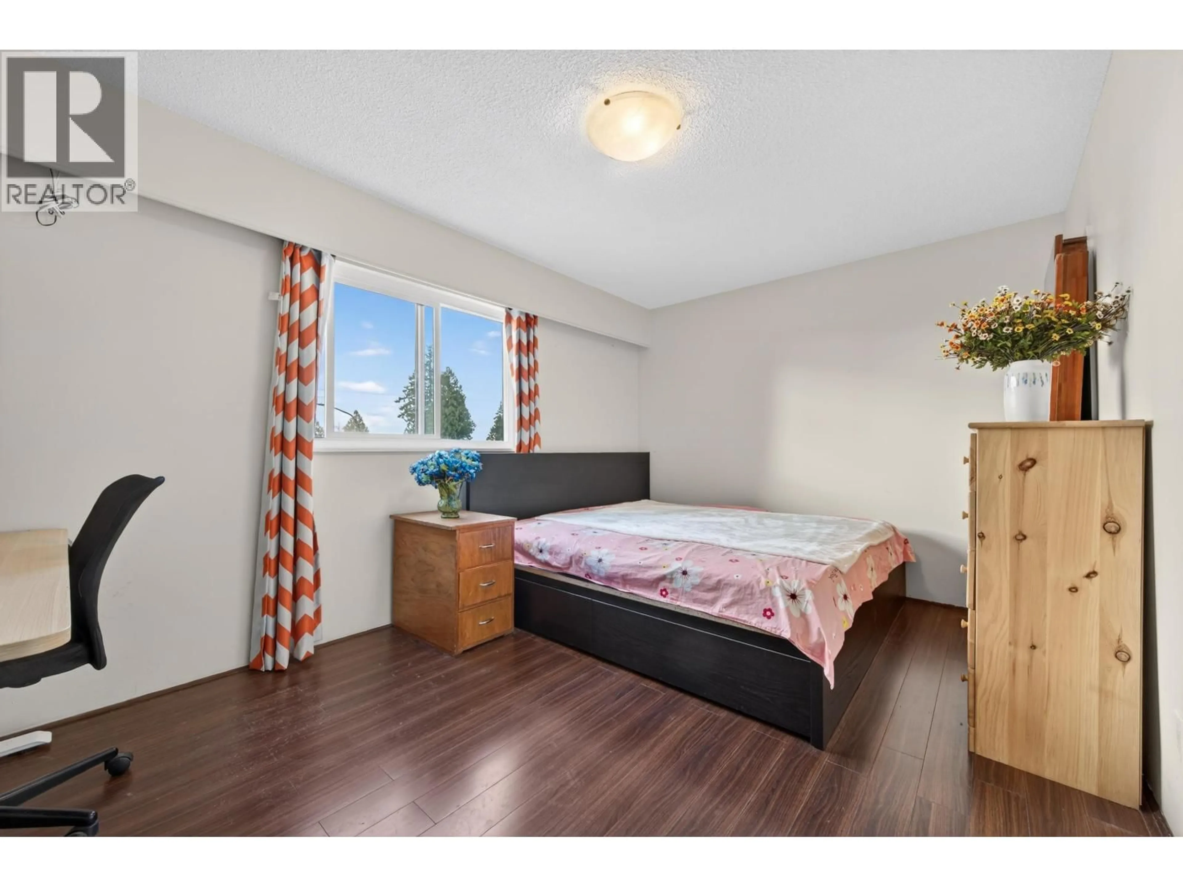 Bedroom with bed, wood/laminate floor for 202 - 4695 IMPERIAL STREET, Burnaby British Columbia V5J1B9
