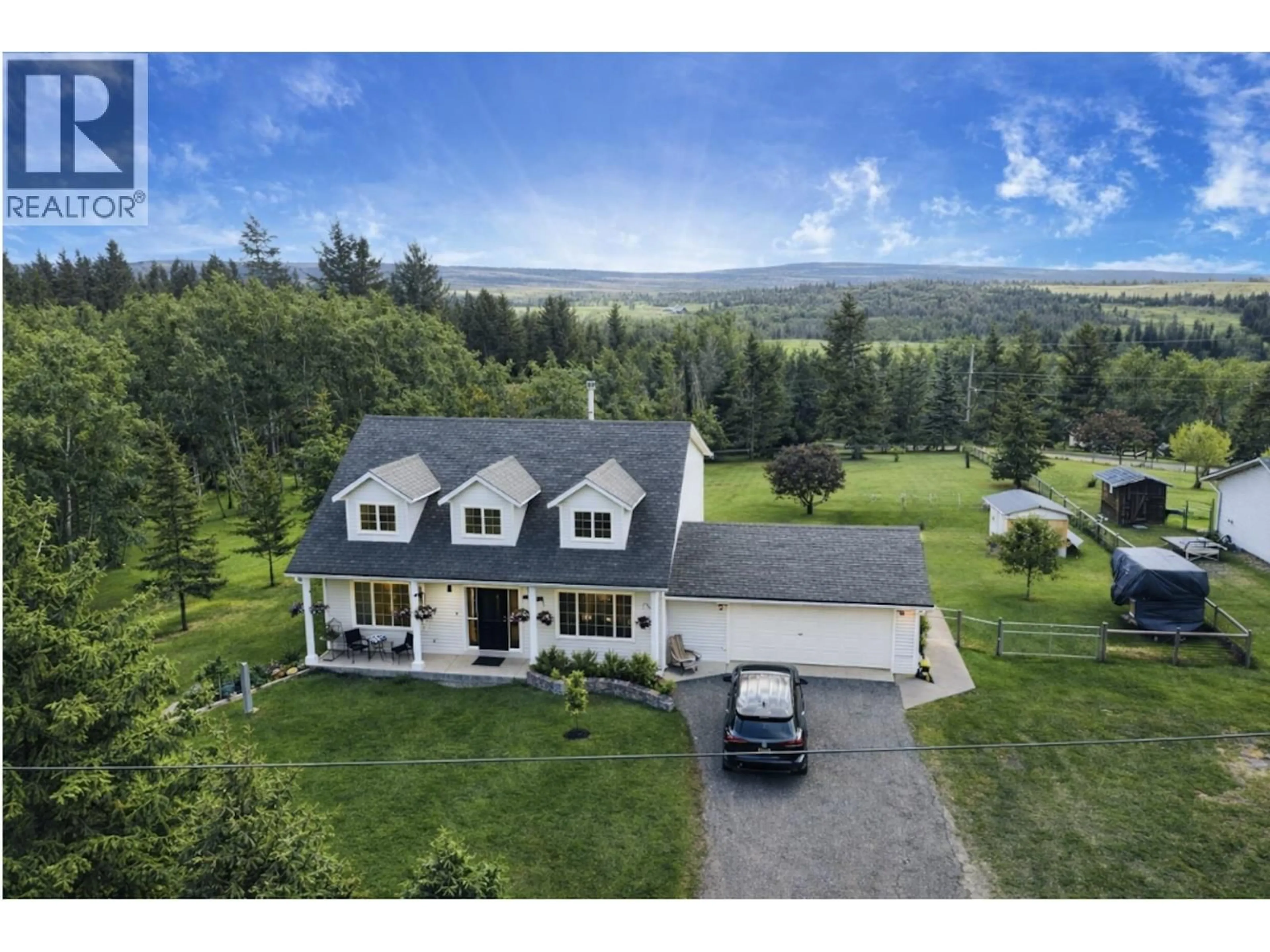 A pic from outside/outdoor area/front of a property/back of a property/a pic from drone, mountain view for 5028 MEIN ROAD, 108 Mile Ranch British Columbia V0K2Z0