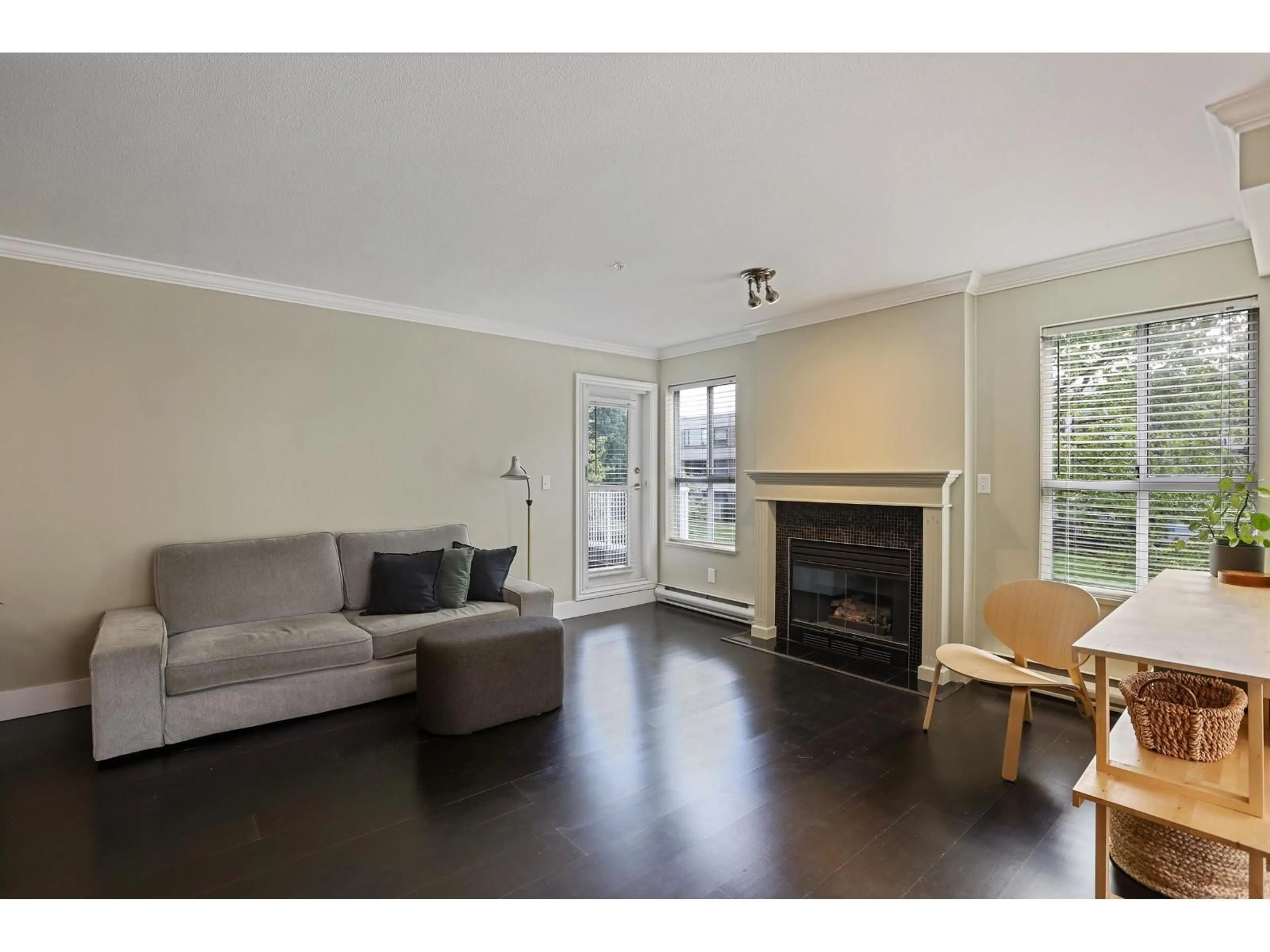 Living room with furniture, wood/laminate floor for 203 - 15272 20 AVENUE, Surrey British Columbia V4A2A3