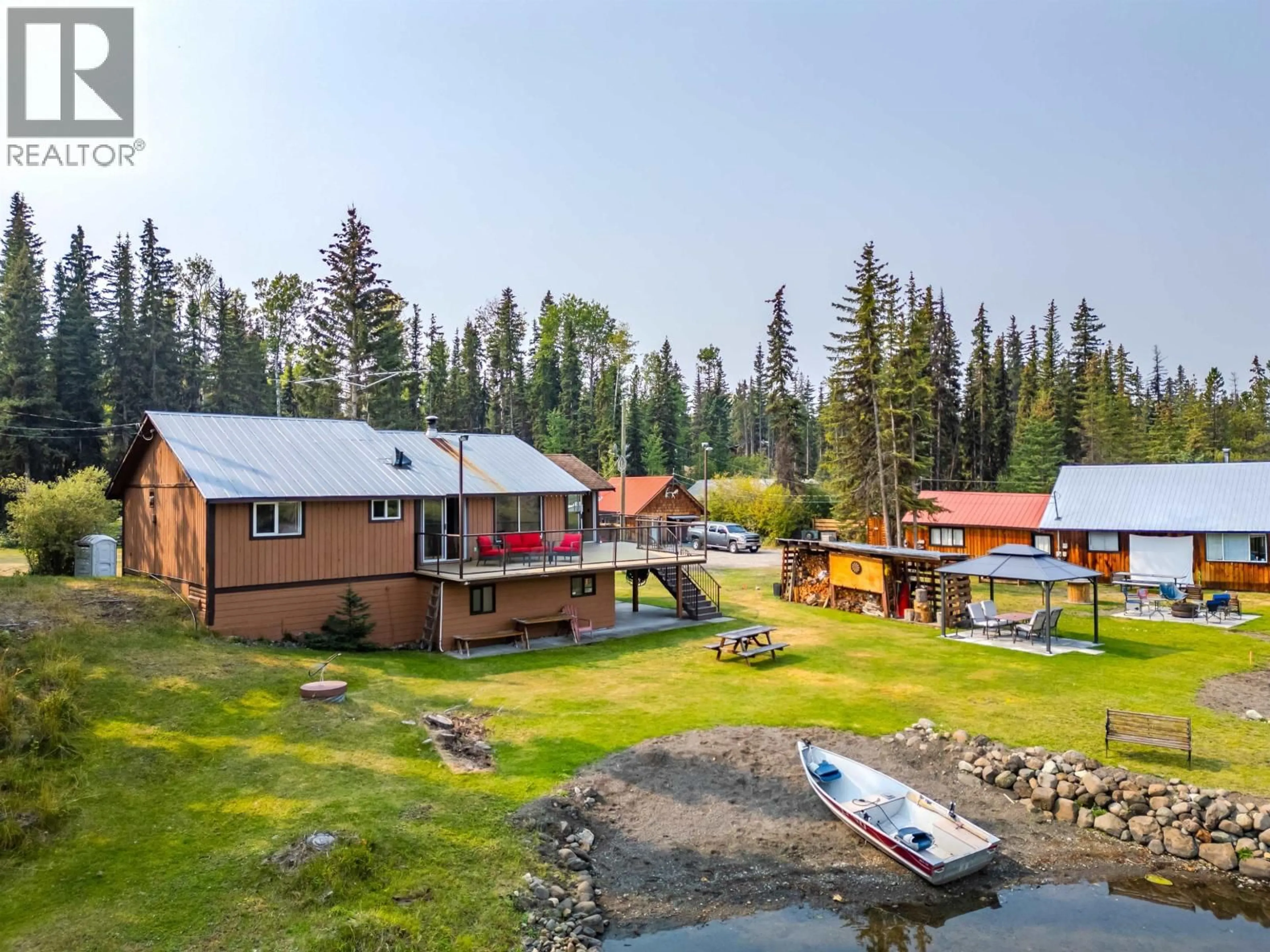 A pic from outside/outdoor area/front of a property/back of a property/a pic from drone, water/lake/river/ocean view for 7177 NATH ROAD, Bridge Lake British Columbia V0K1X1