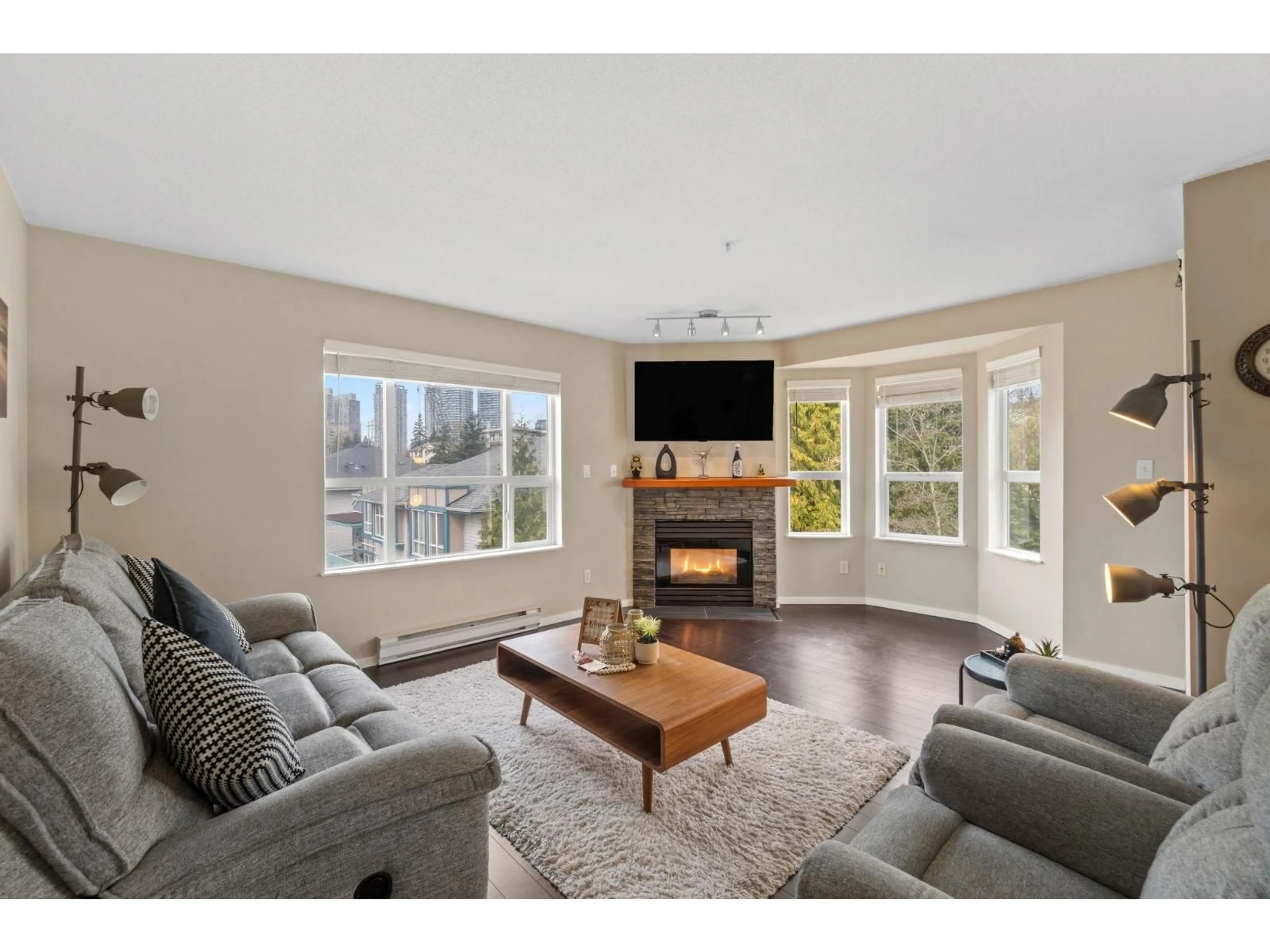 Living room with furniture, wood/laminate floor for 405 - 13955 LAUREL DRIVE, Surrey British Columbia V3T1A8
