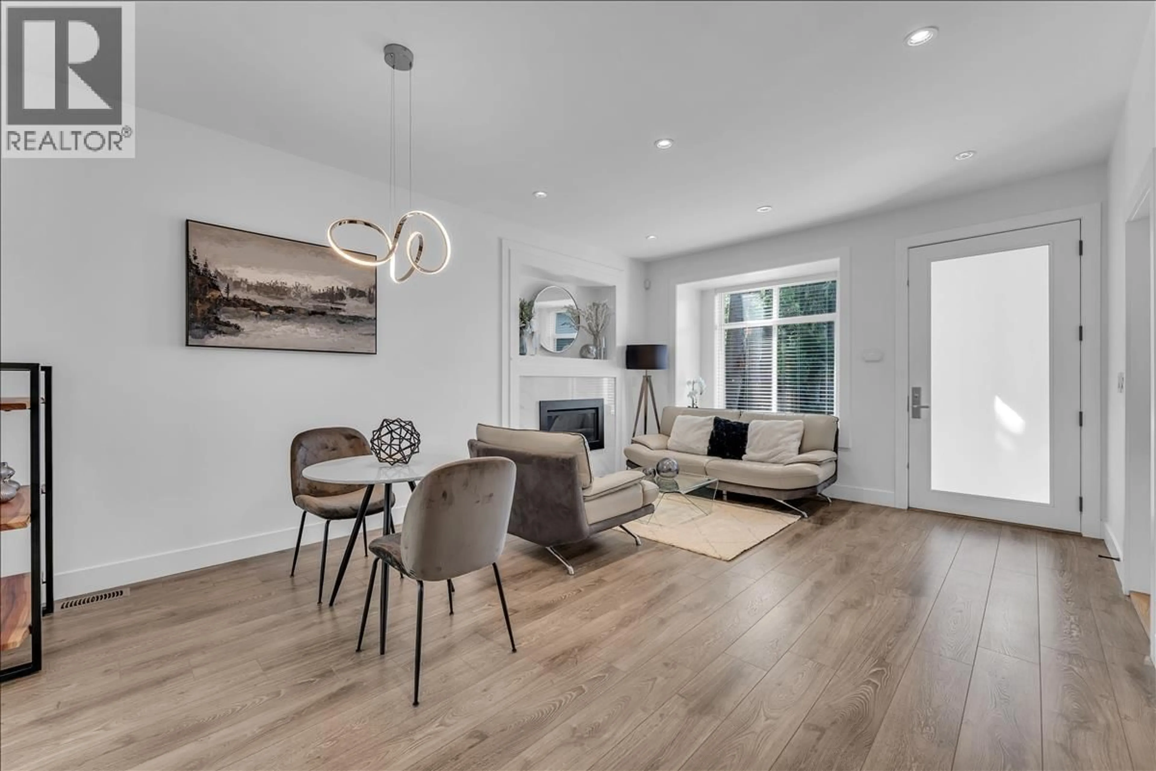 Living room with furniture, wood/laminate floor for 7430 CANADA WAY, Burnaby British Columbia V3N3J6