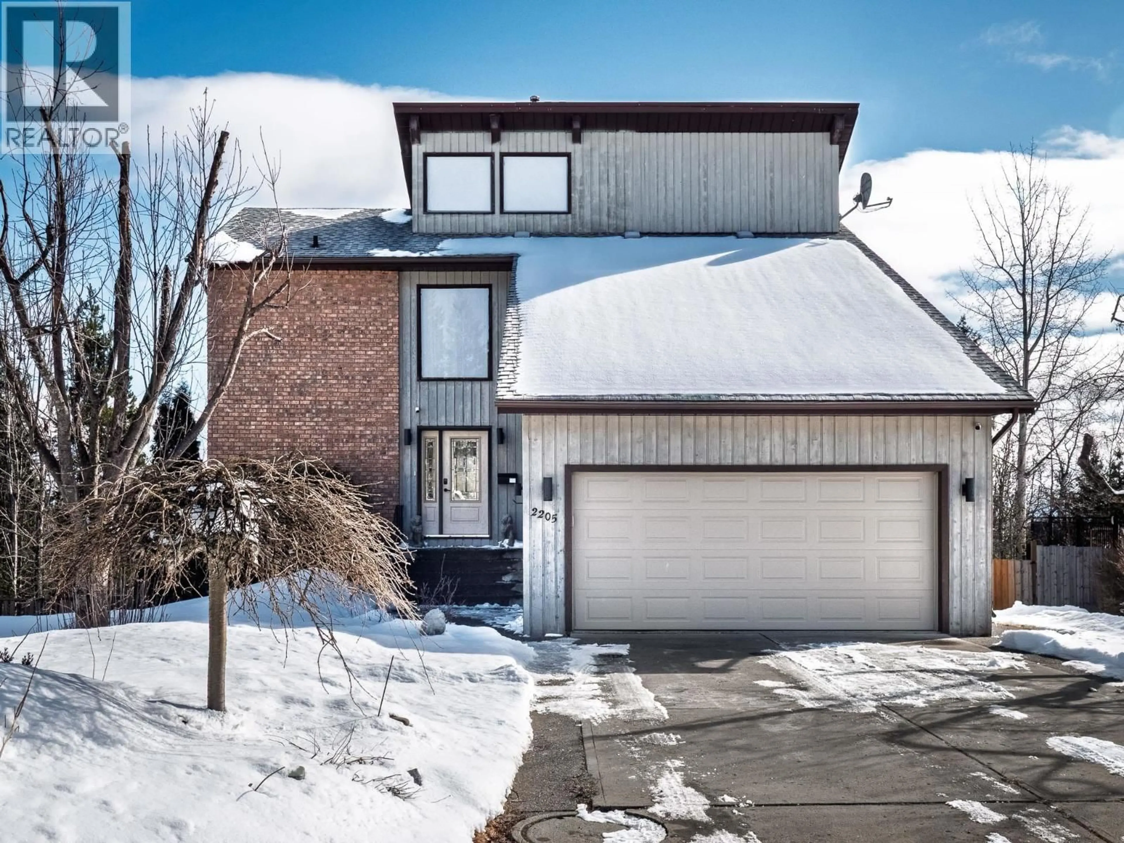 Home with brick exterior material, street for 2205 CARLISLE PLACE, Prince George British Columbia V2K4B8