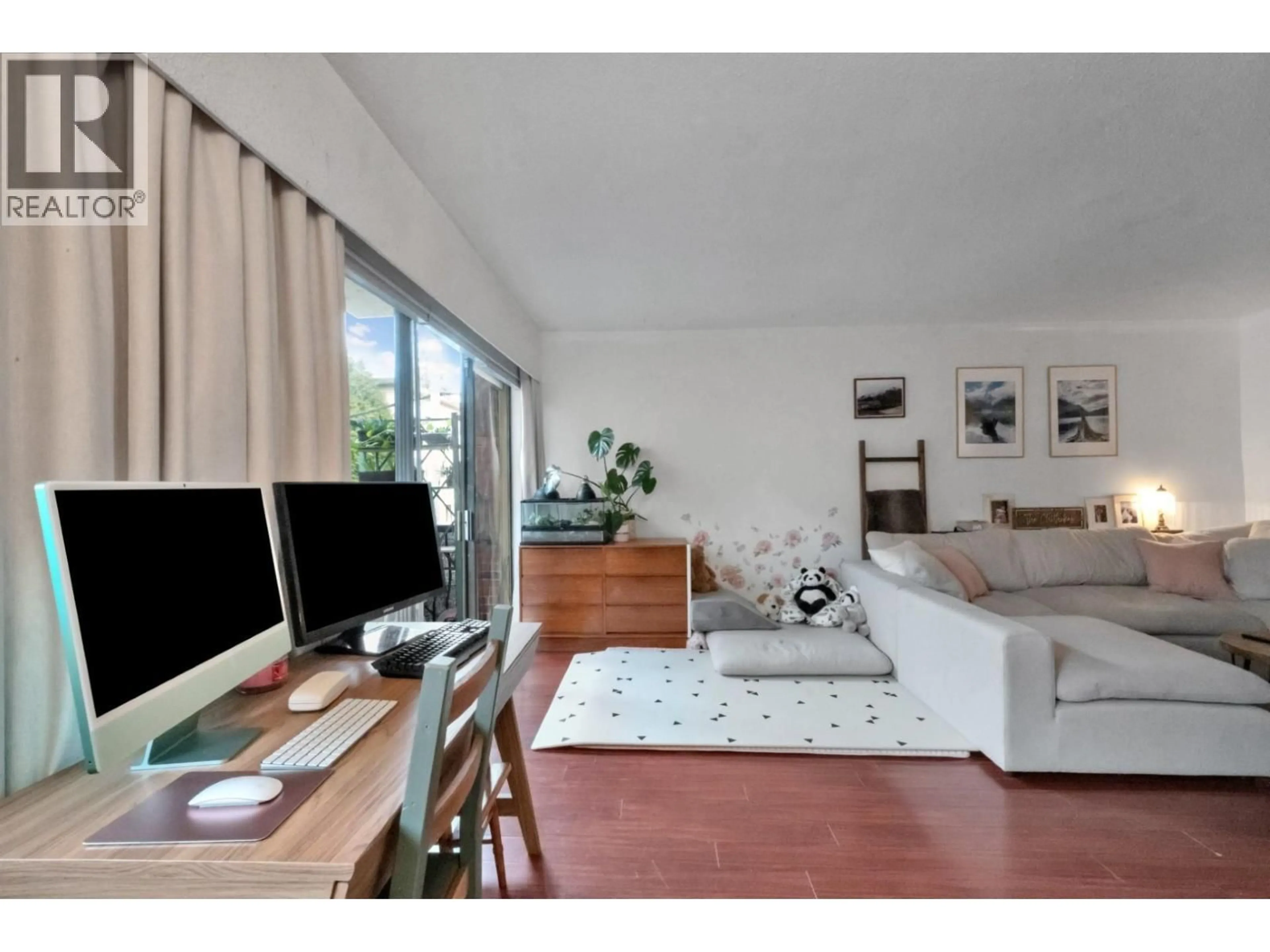 Living room with furniture, wood/laminate floor for 103 - 214 15TH STREET, North Vancouver British Columbia V7L2R3