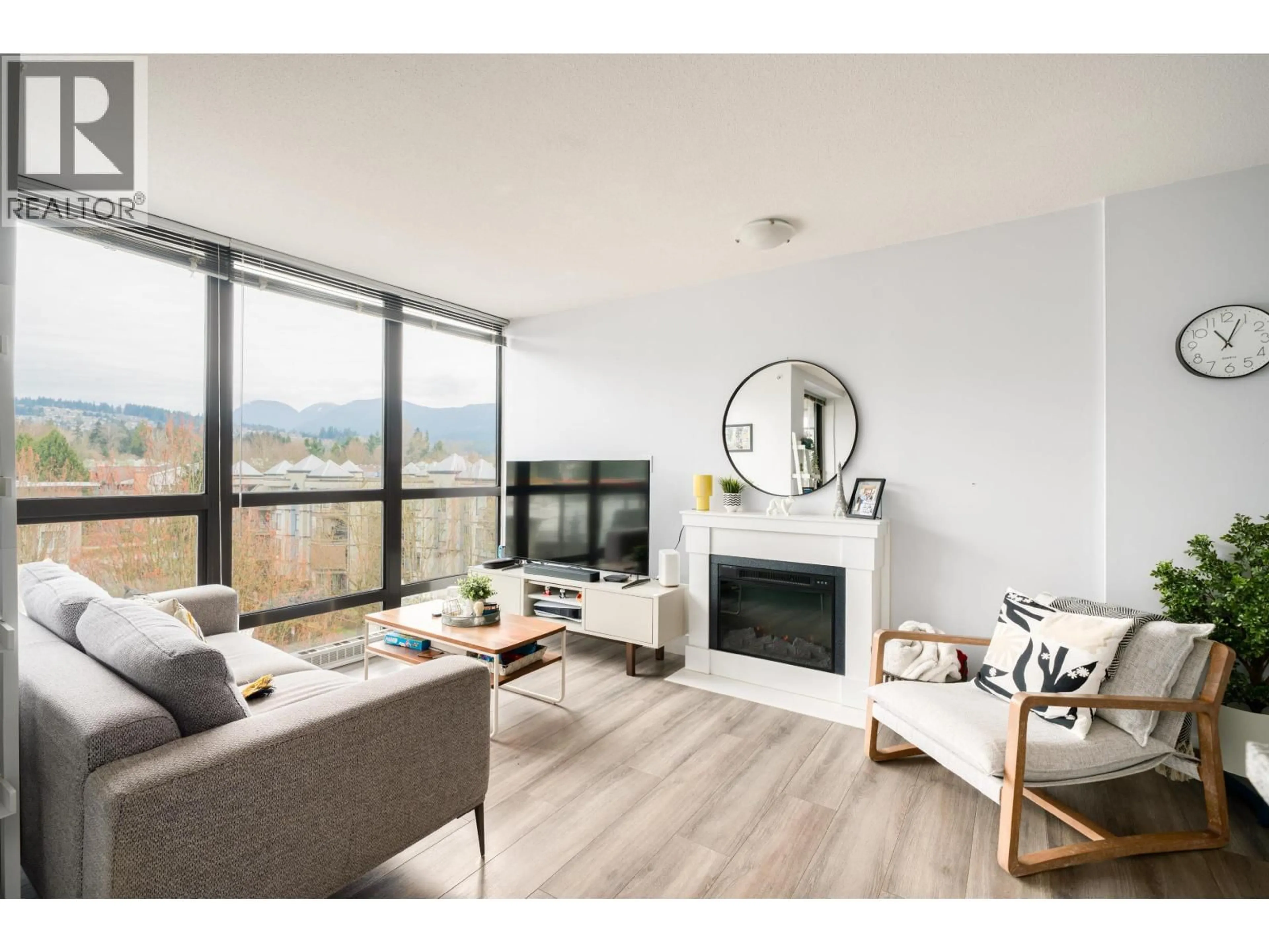 Living room with furniture, wood/laminate floor for 702 - 2959 GLEN DRIVE, Coquitlam British Columbia V3B0B8