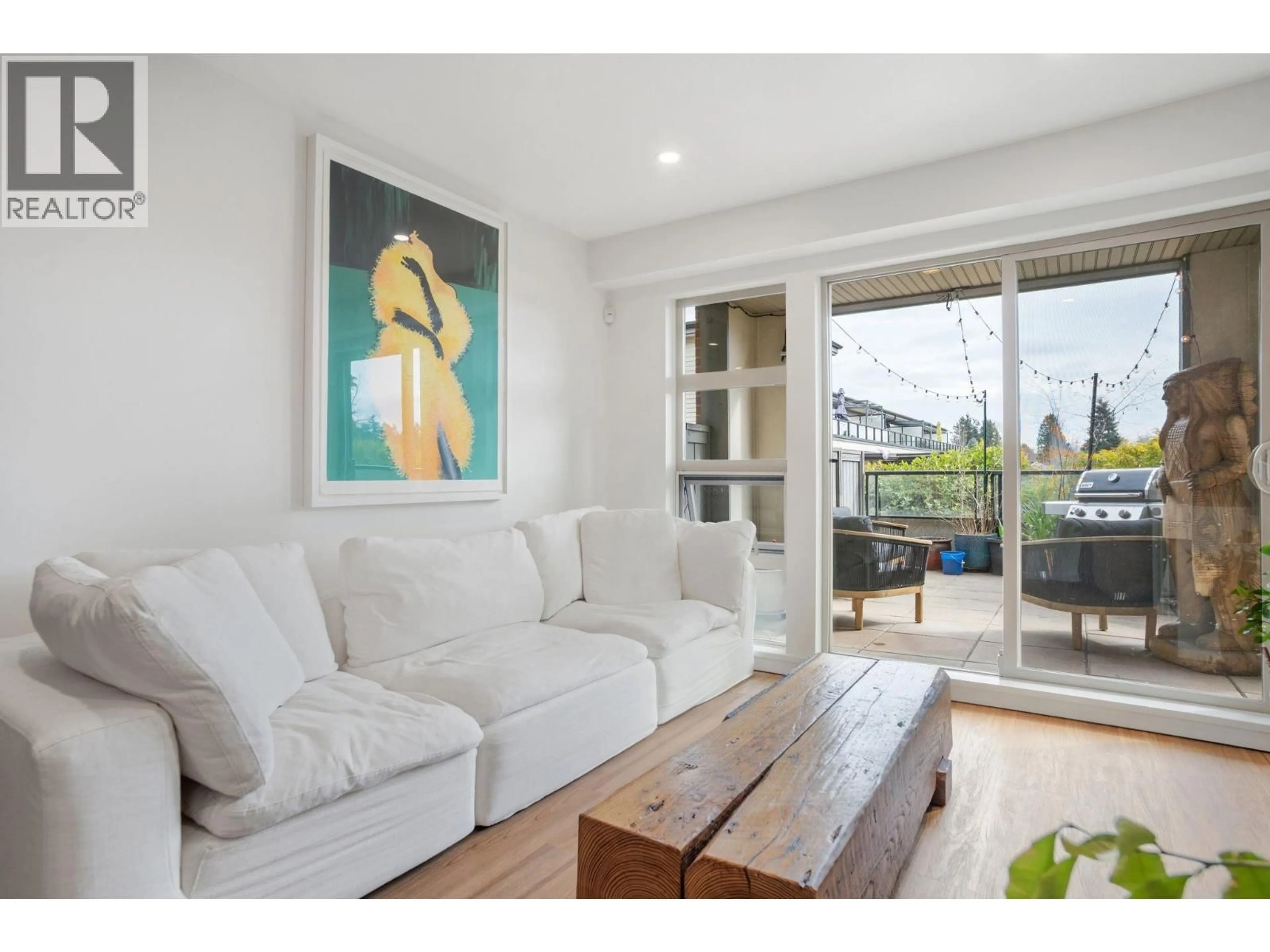 Living room with furniture, wood/laminate floor for 218 - 4550 FRASER STREET, Vancouver British Columbia V5V4G8