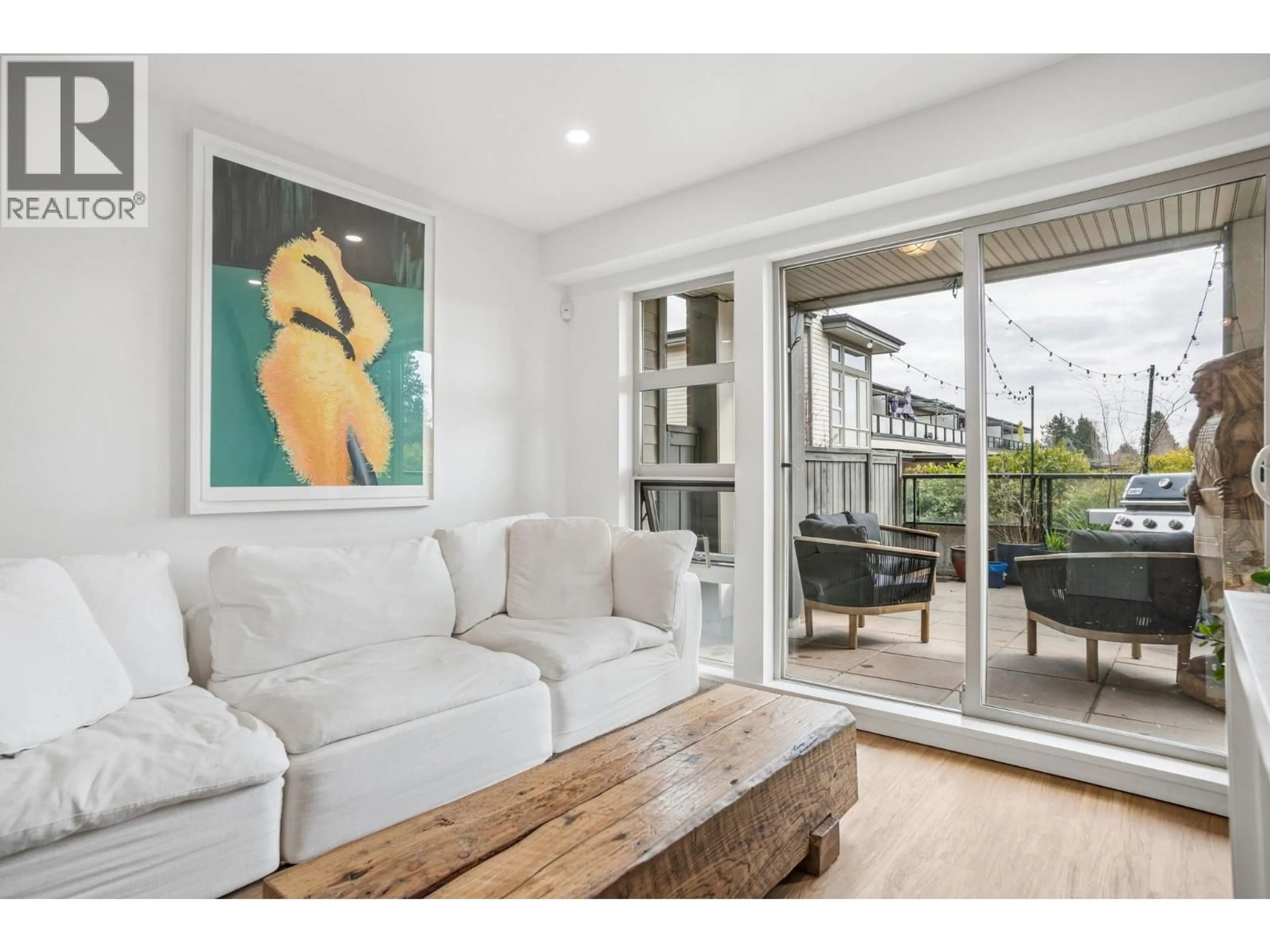 Living room with furniture, wood/laminate floor for 218 - 4550 FRASER STREET, Vancouver British Columbia V5V4G8