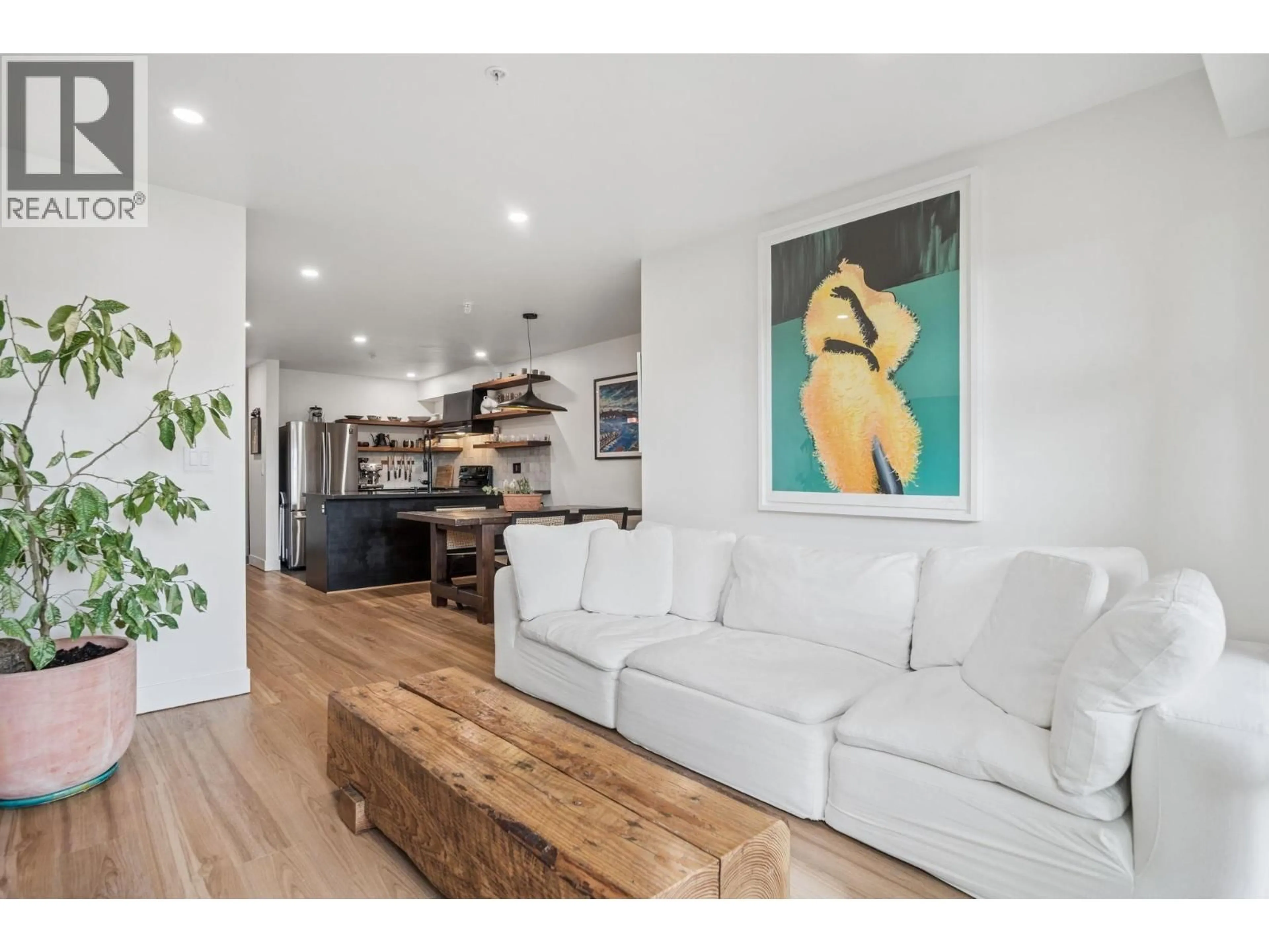 Living room with furniture, wood/laminate floor for 218 - 4550 FRASER STREET, Vancouver British Columbia V5V4G8