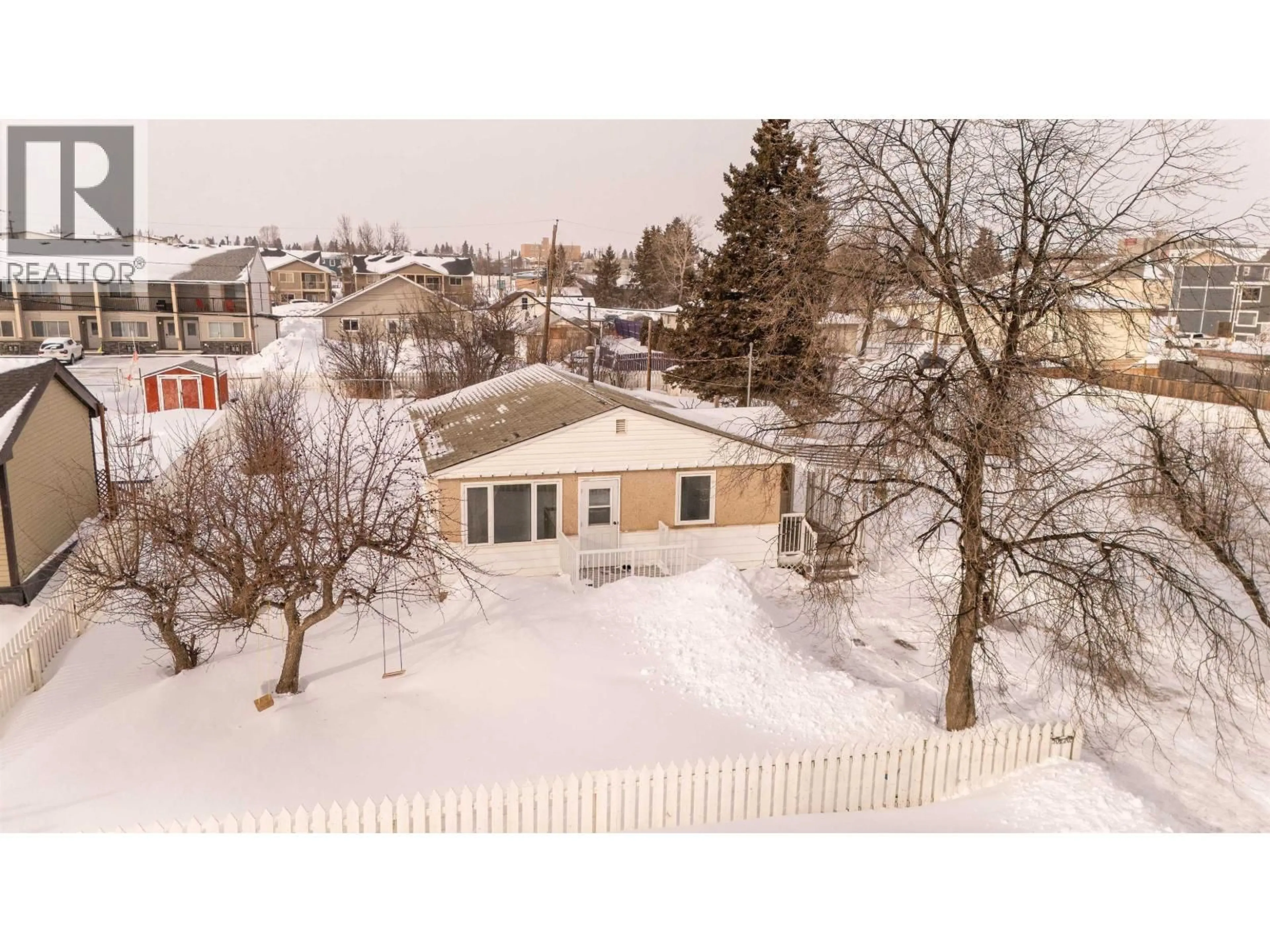 A pic from outside/outdoor area/front of a property/back of a property/a pic from drone, street for 10220 96 AVENUE, Fort St. John British Columbia V1J1L4