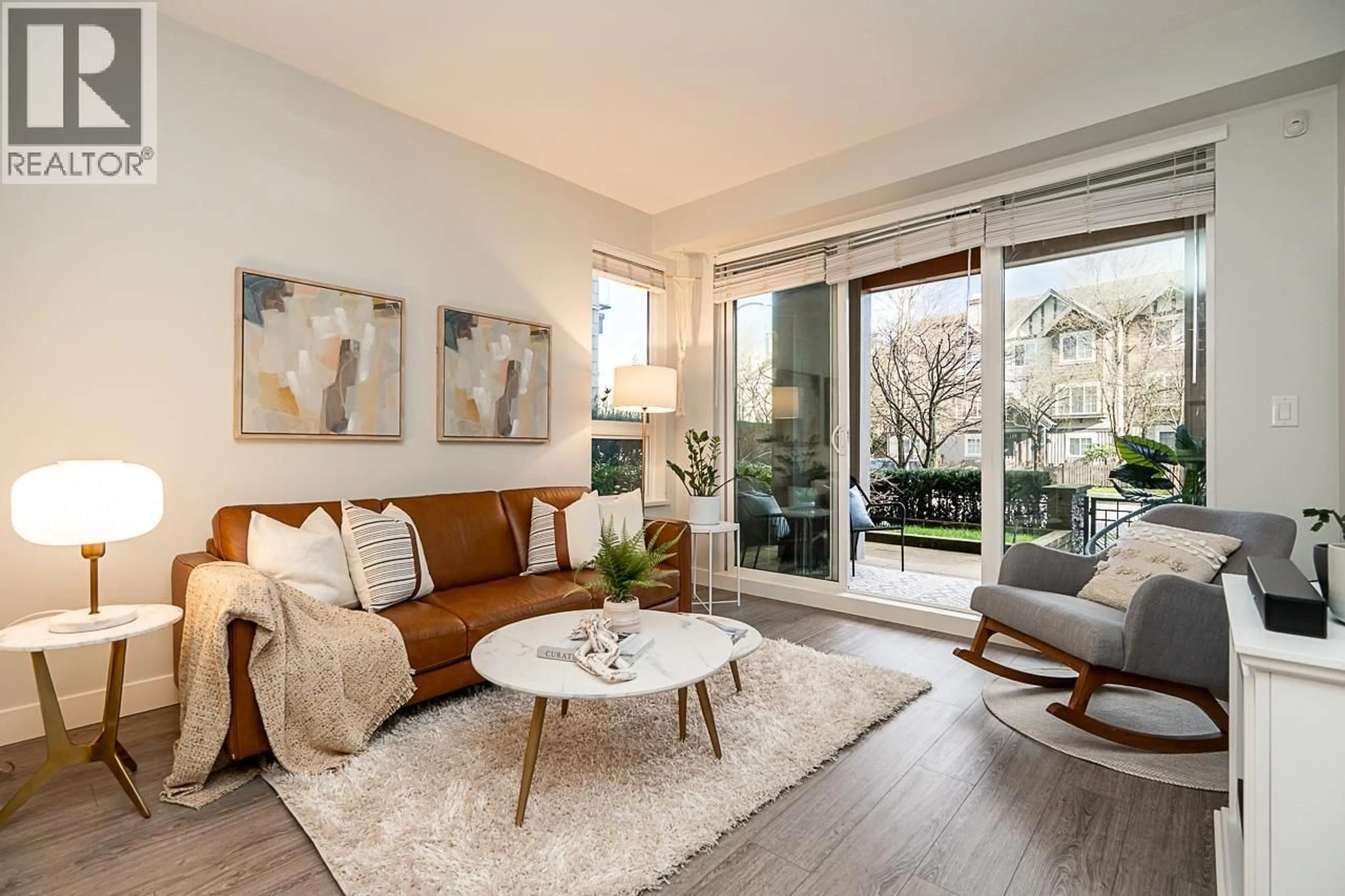 Living room with furniture, wood/laminate floor for 210 - 3399 NOEL DRIVE, Burnaby British Columbia V3J0G8