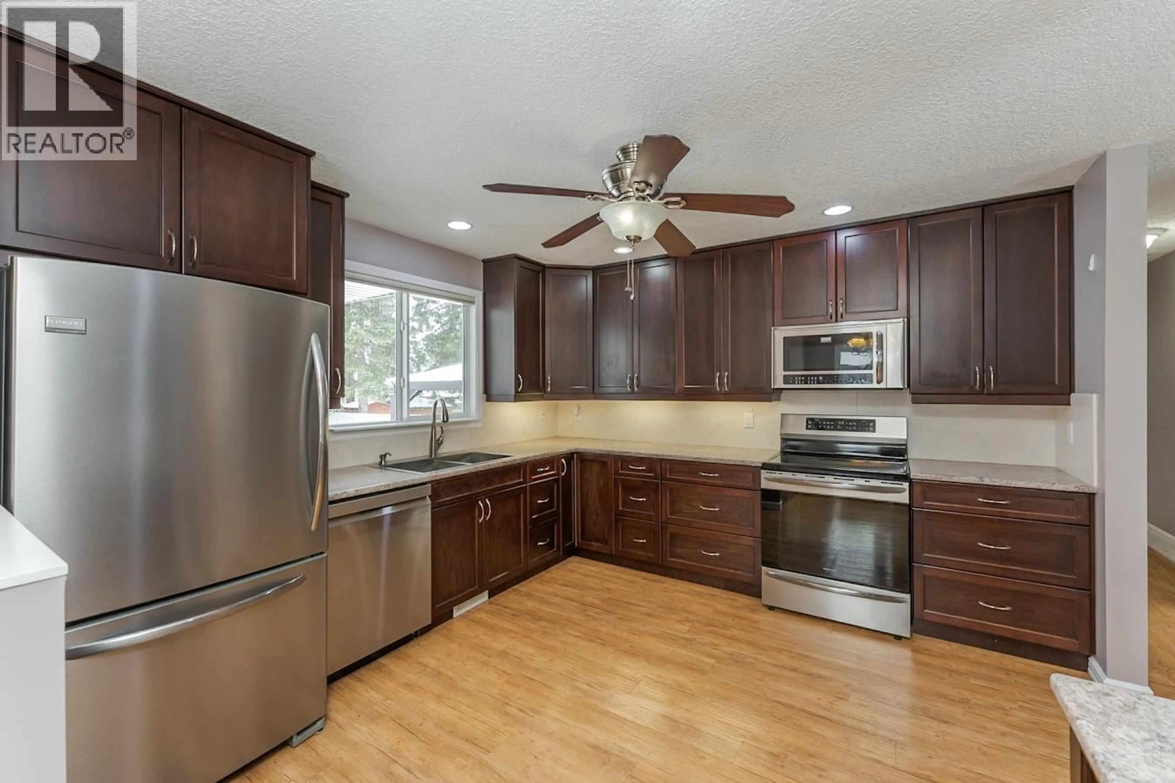 Open concept kitchen, wood/laminate floor for 5904 OXFORD PLACE, Prince George British Columbia V2N2E8