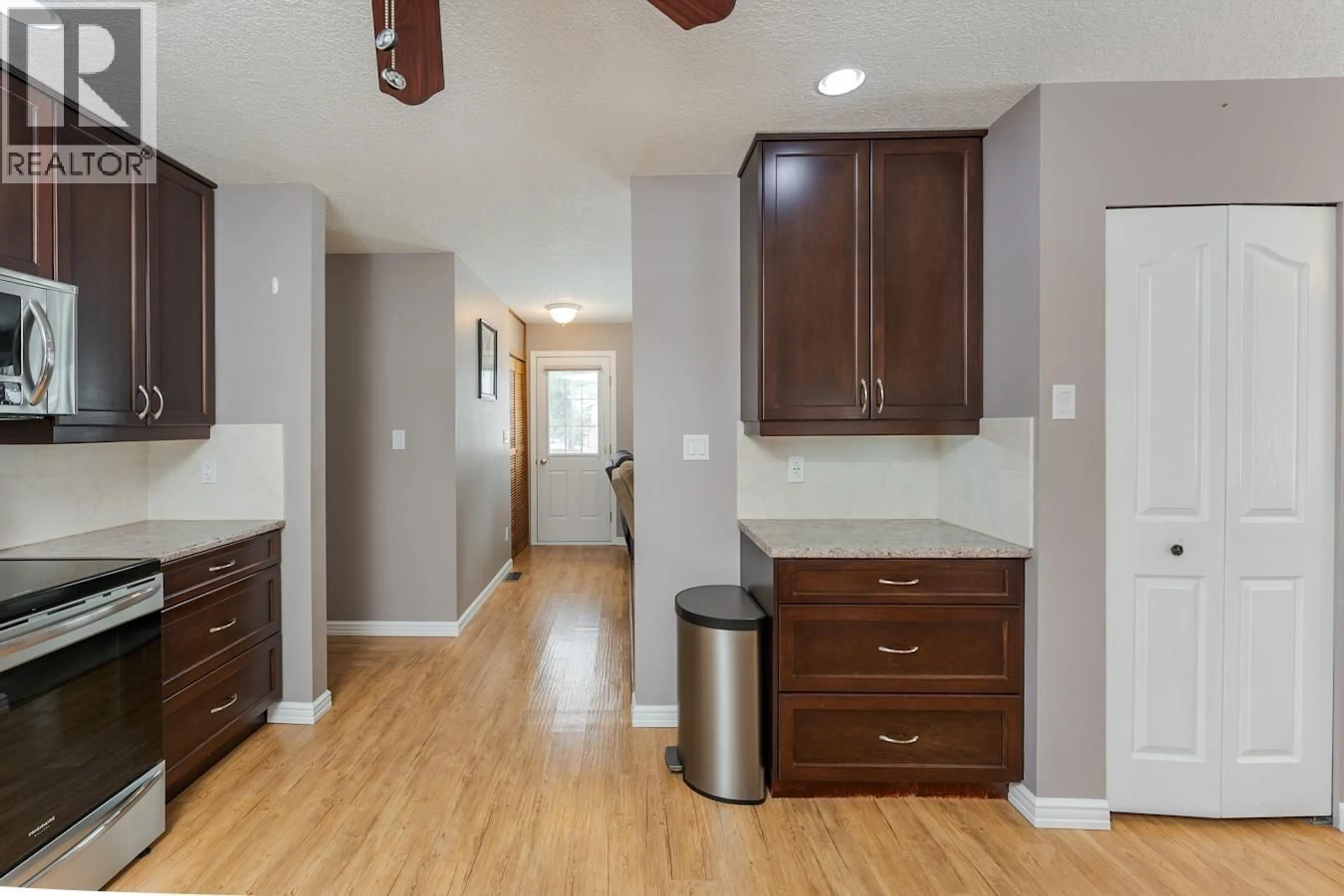 Open concept kitchen, wood/laminate floor for 5904 OXFORD PLACE, Prince George British Columbia V2N2E8