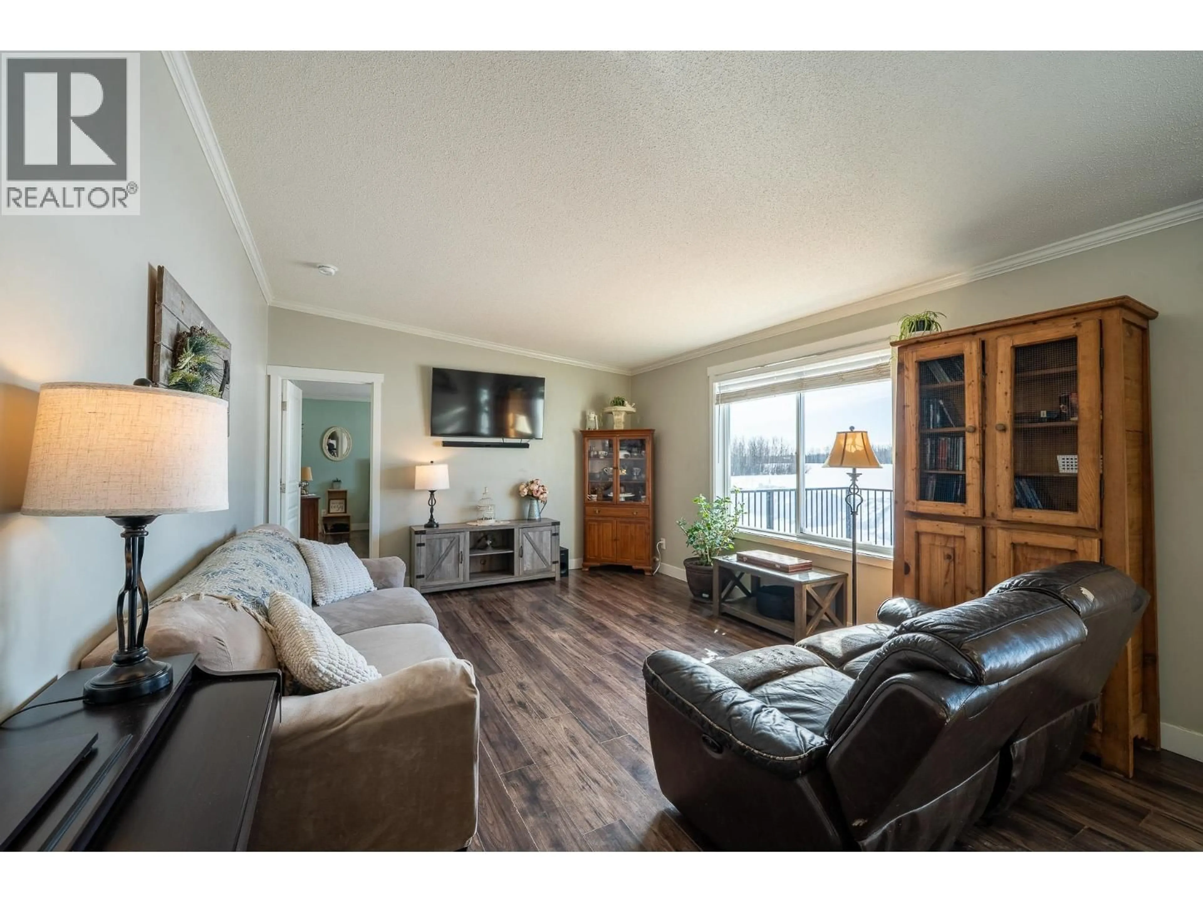 Living room with furniture, wood/laminate floor for 17053 PRESPATOU ROAD, Fort St. John British Columbia V0C2S0