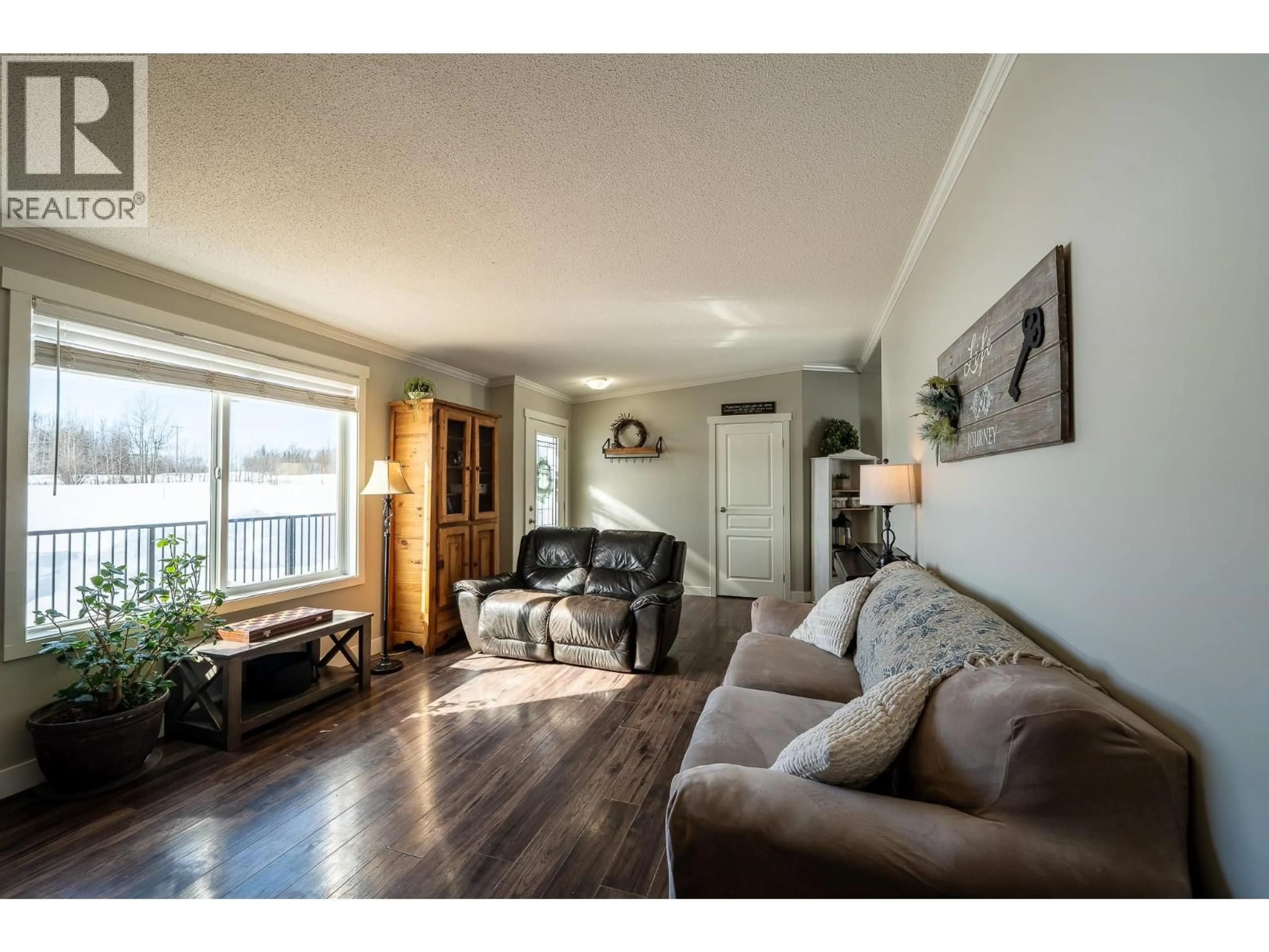 Living room with furniture, wood/laminate floor for 17053 PRESPATOU ROAD, Fort St. John British Columbia V0C2S0