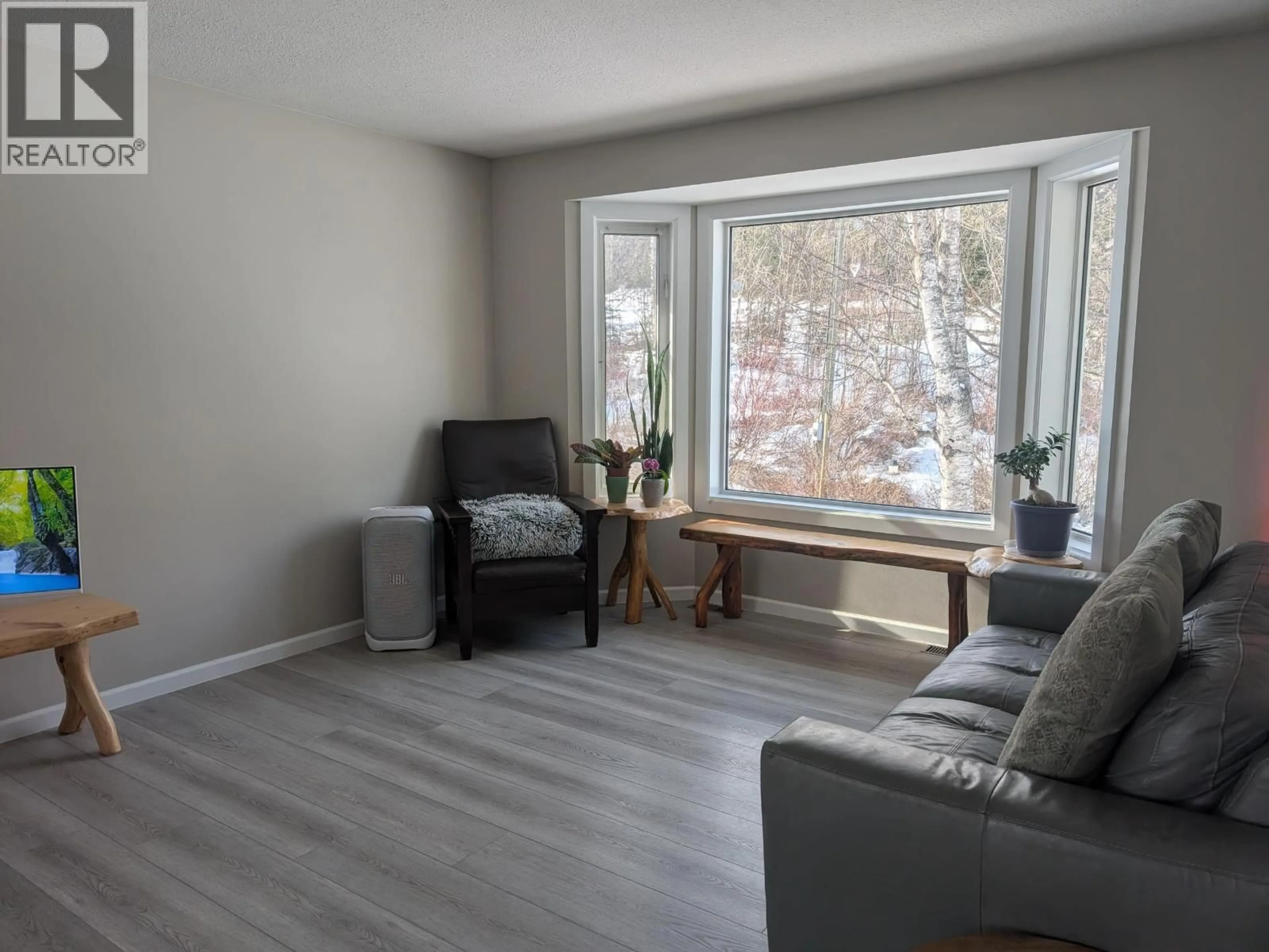 Living room with furniture, wood/laminate floor for 9054 HORLINGS ROAD, Smithers British Columbia V0J2N2