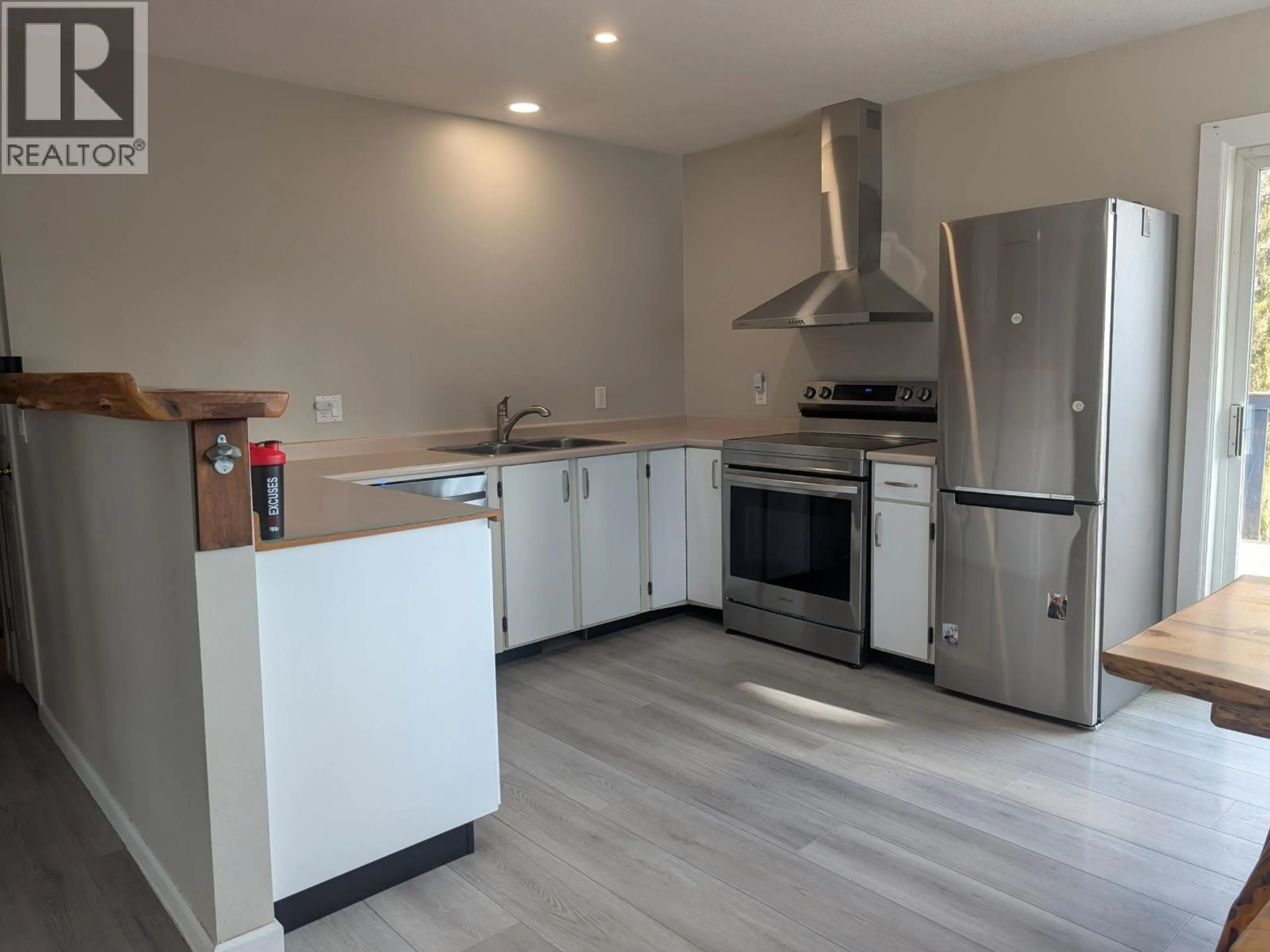 Open concept kitchen, wood/laminate floor for 9054 HORLINGS ROAD, Smithers British Columbia V0J2N2