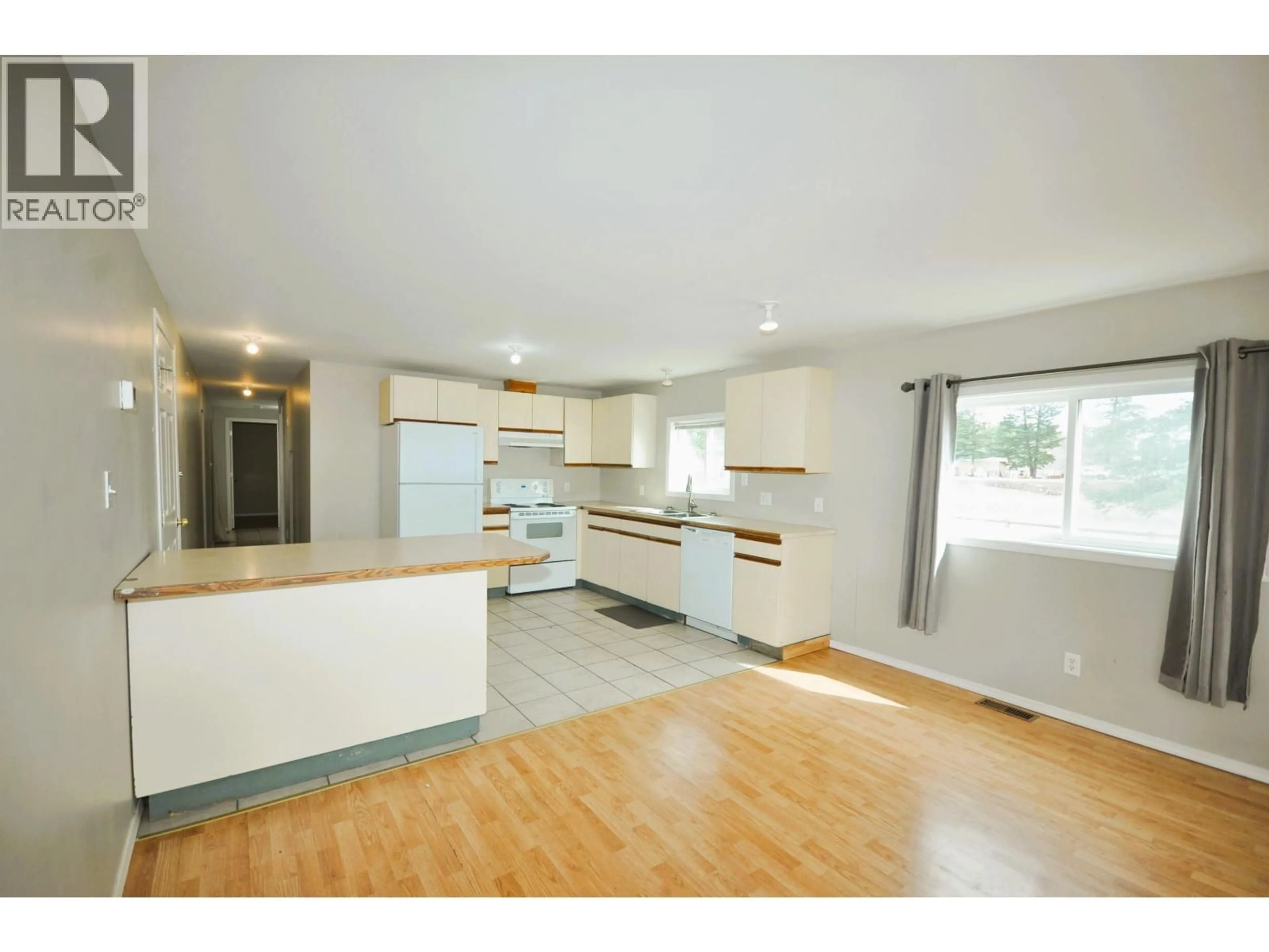 Open concept kitchen, wood/laminate floor for 3238 HINSCHE ROAD, 150 Mile House British Columbia V0L1K0