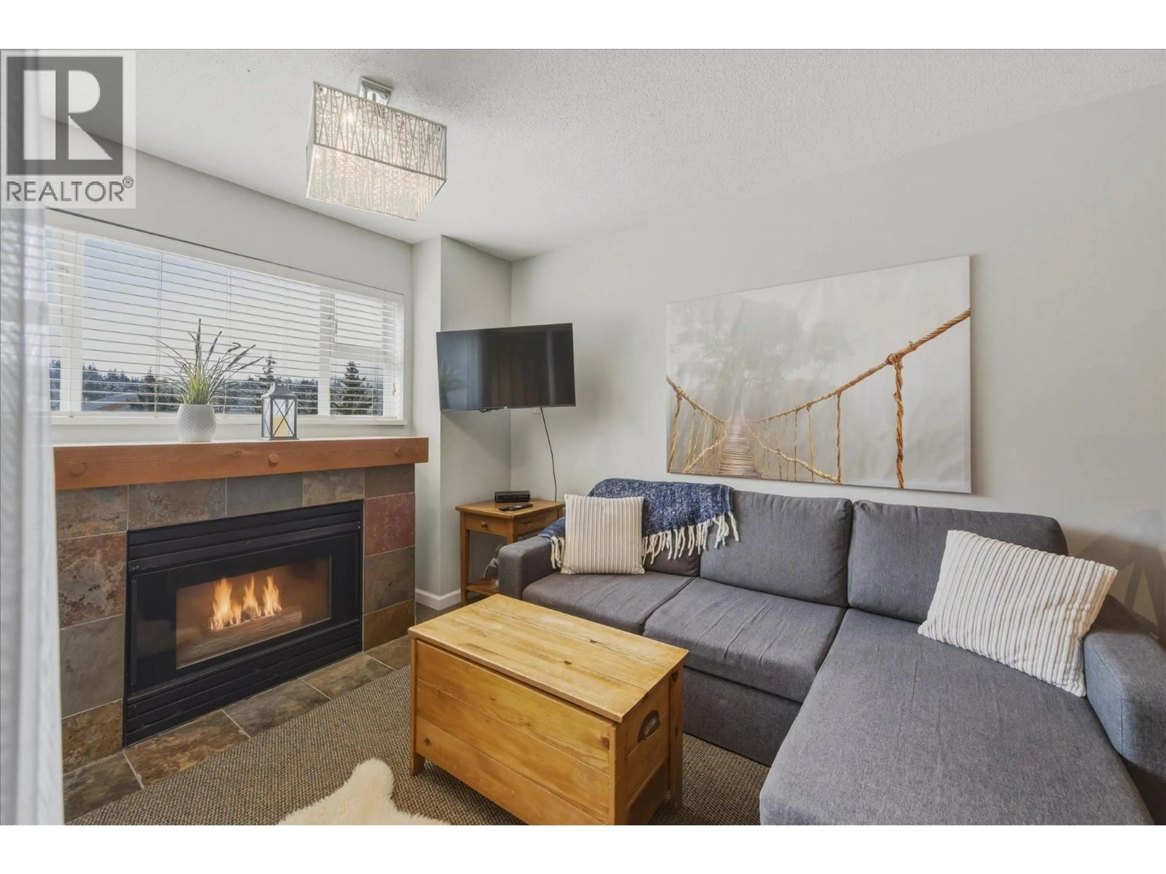 Living room with furniture, wood/laminate floor for 308 - 4360 LORIMER ROAD, Whistler British Columbia V8E1A5