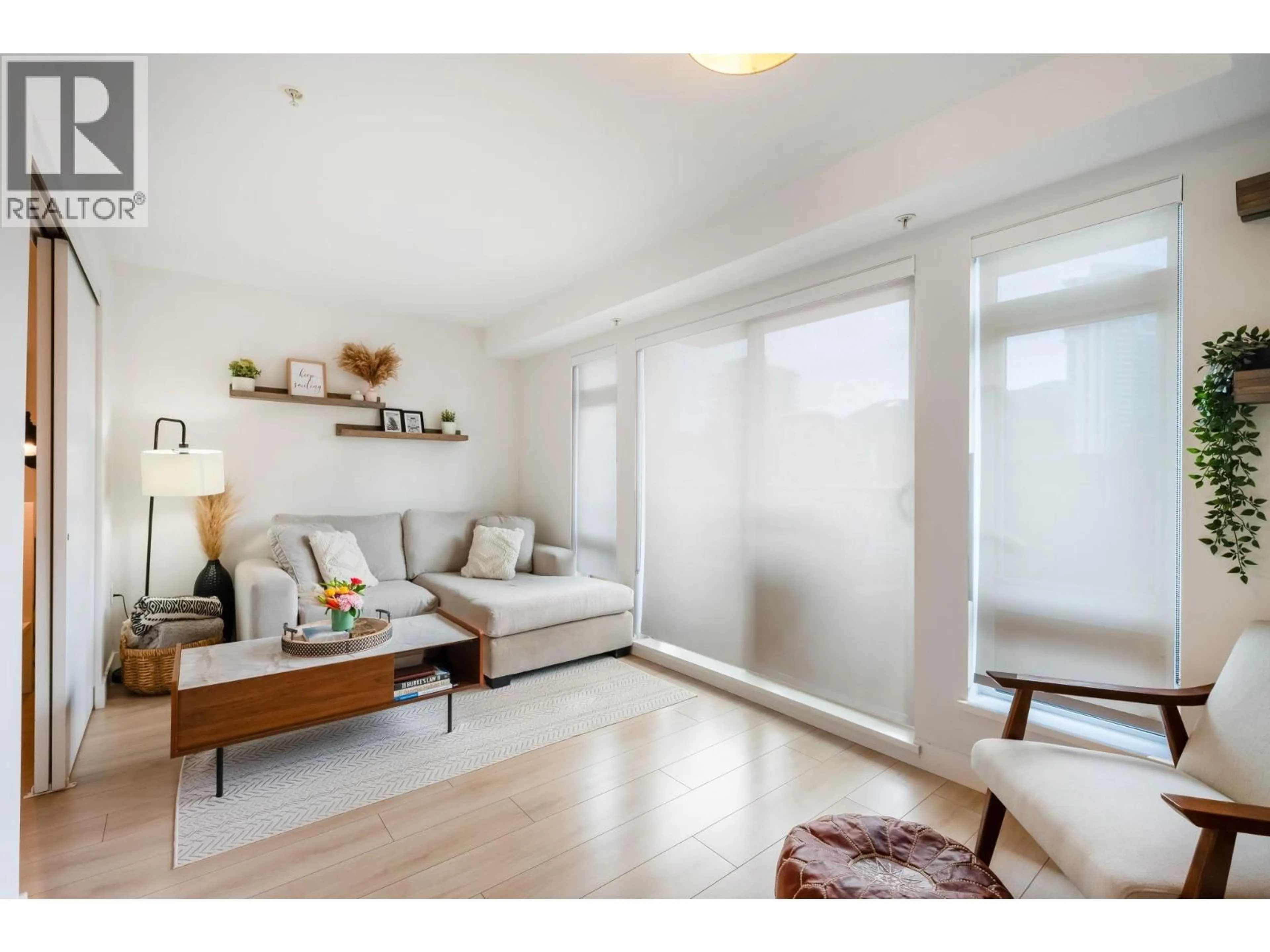 Living room with furniture, wood/laminate floor for 201 - 1519 CROWN STREET, North Vancouver British Columbia V7J1G6