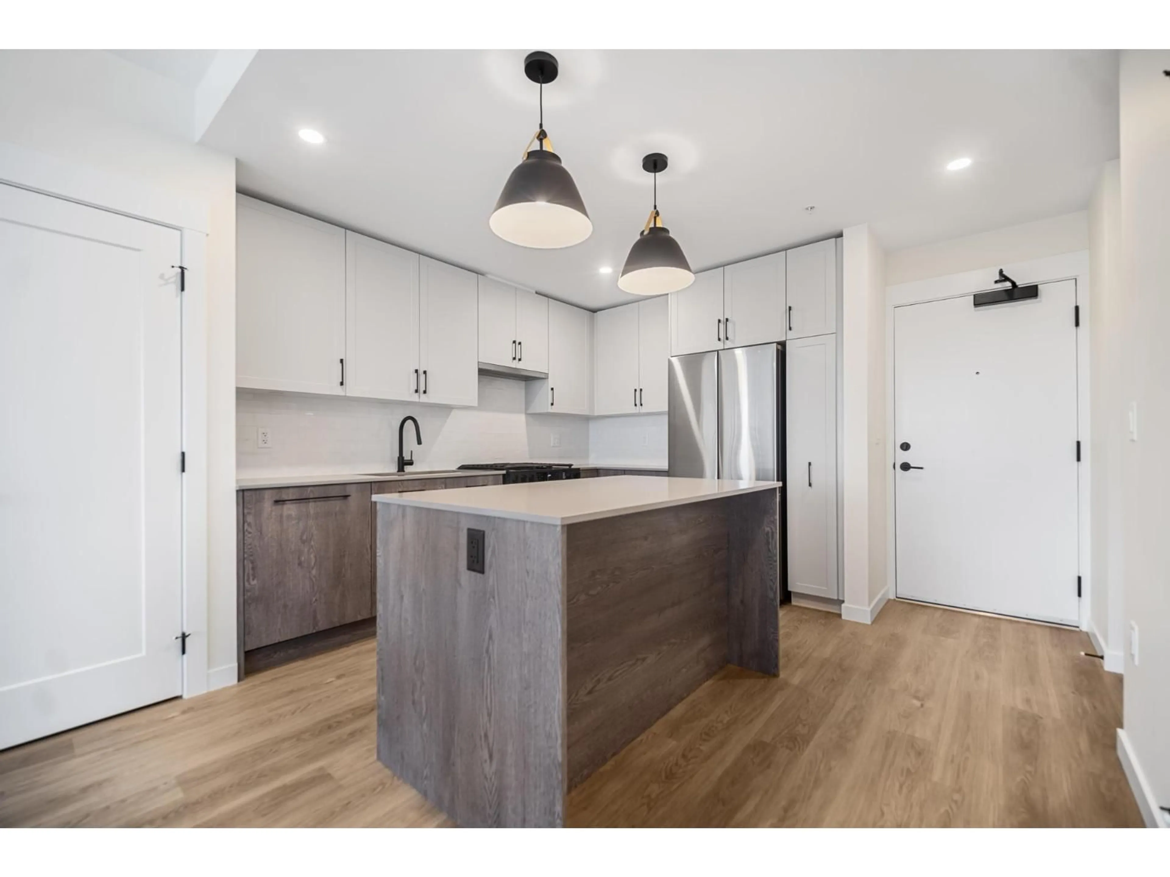 Open concept kitchen, wood/laminate floor for 503 - 27215 ALDERGROVE TOWN CENTRE DRIVE, Langley British Columbia V4W0E3