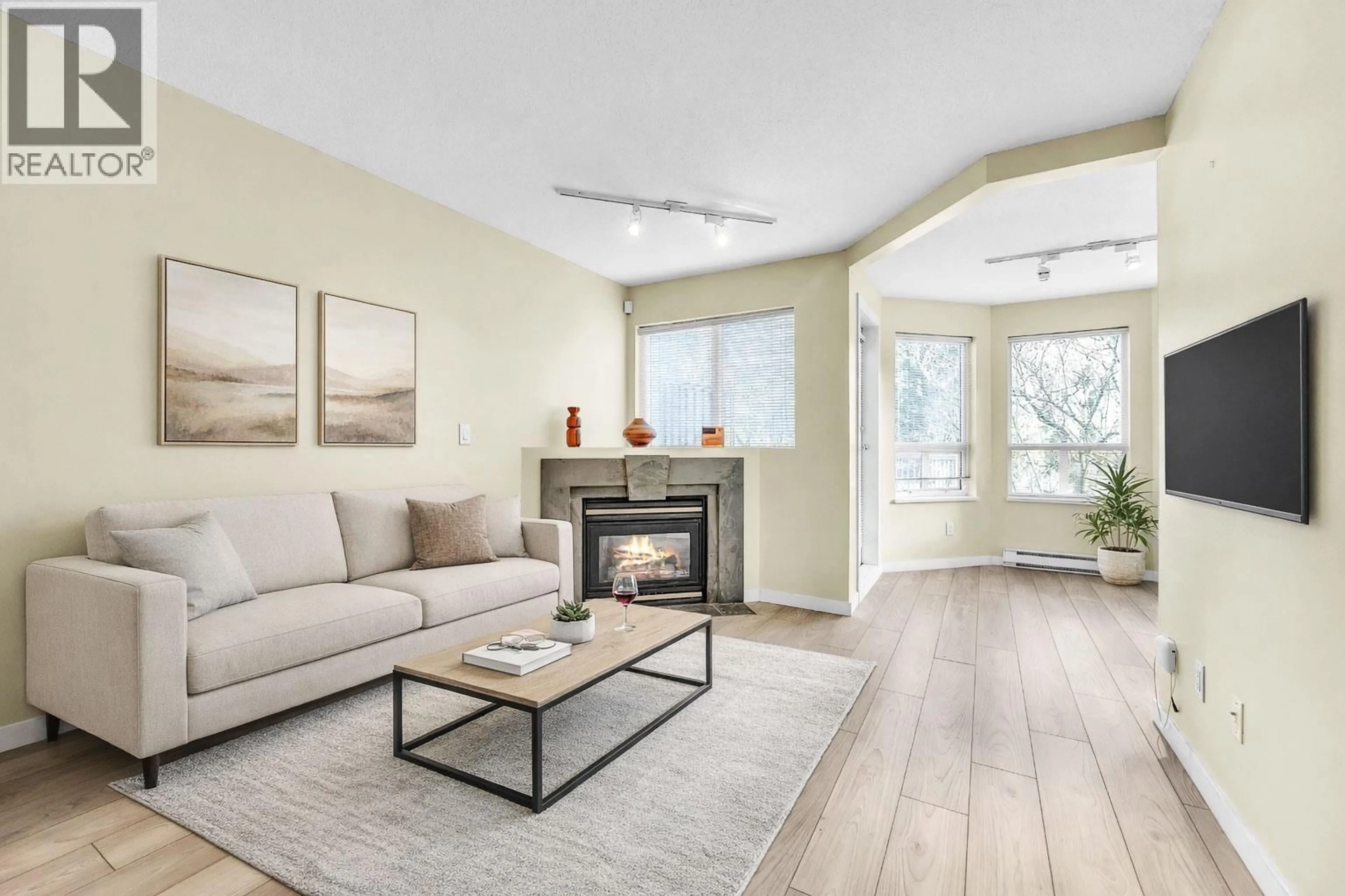 Living room with furniture, wood/laminate floor for 301 - 7383 GRIFFITHS DRIVE, Burnaby British Columbia V5E4M8