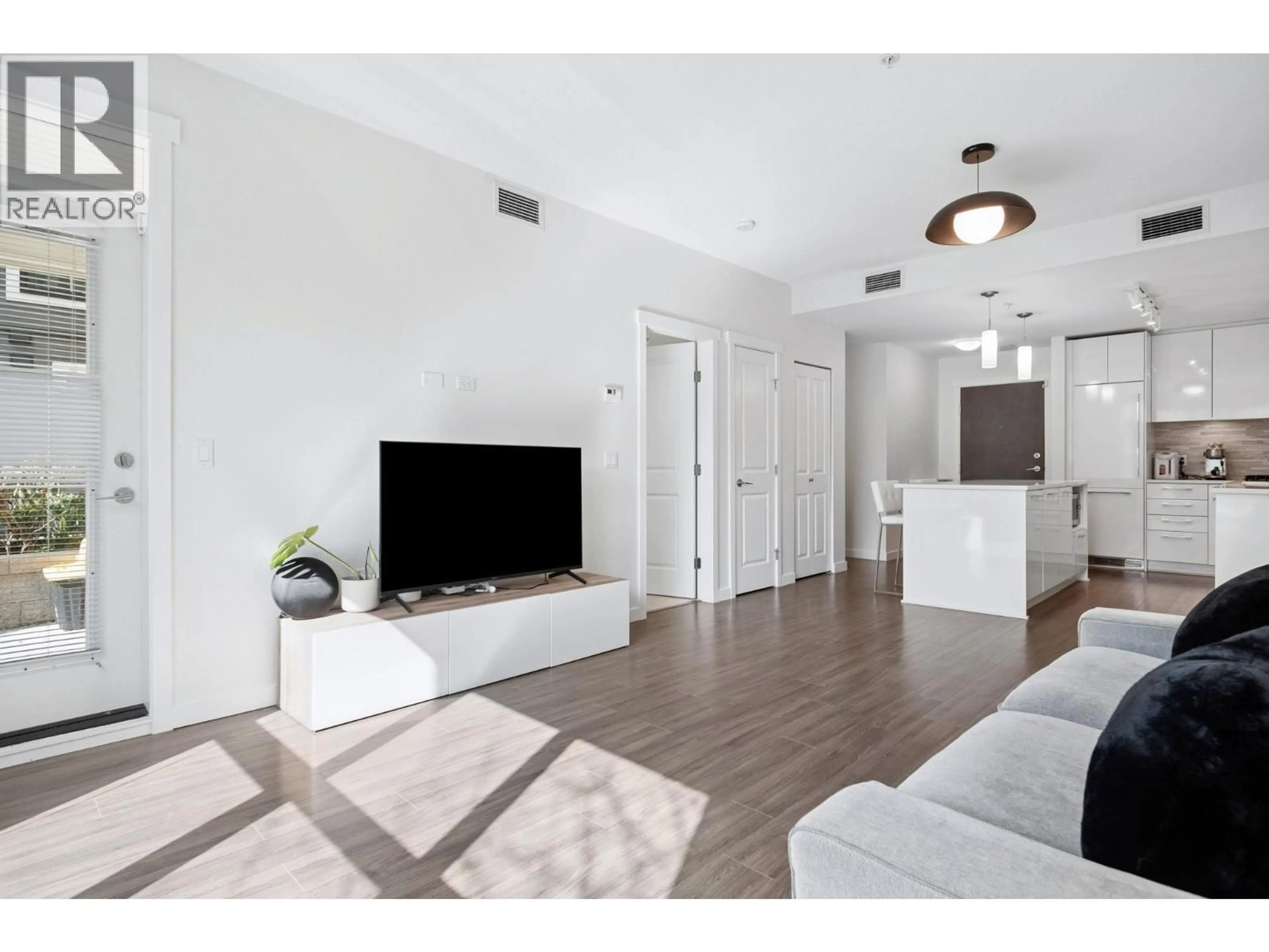 Living room with furniture, wood/laminate floor for 121 - 9500 TOMICKI AVENUE, Richmond British Columbia V6X0R9