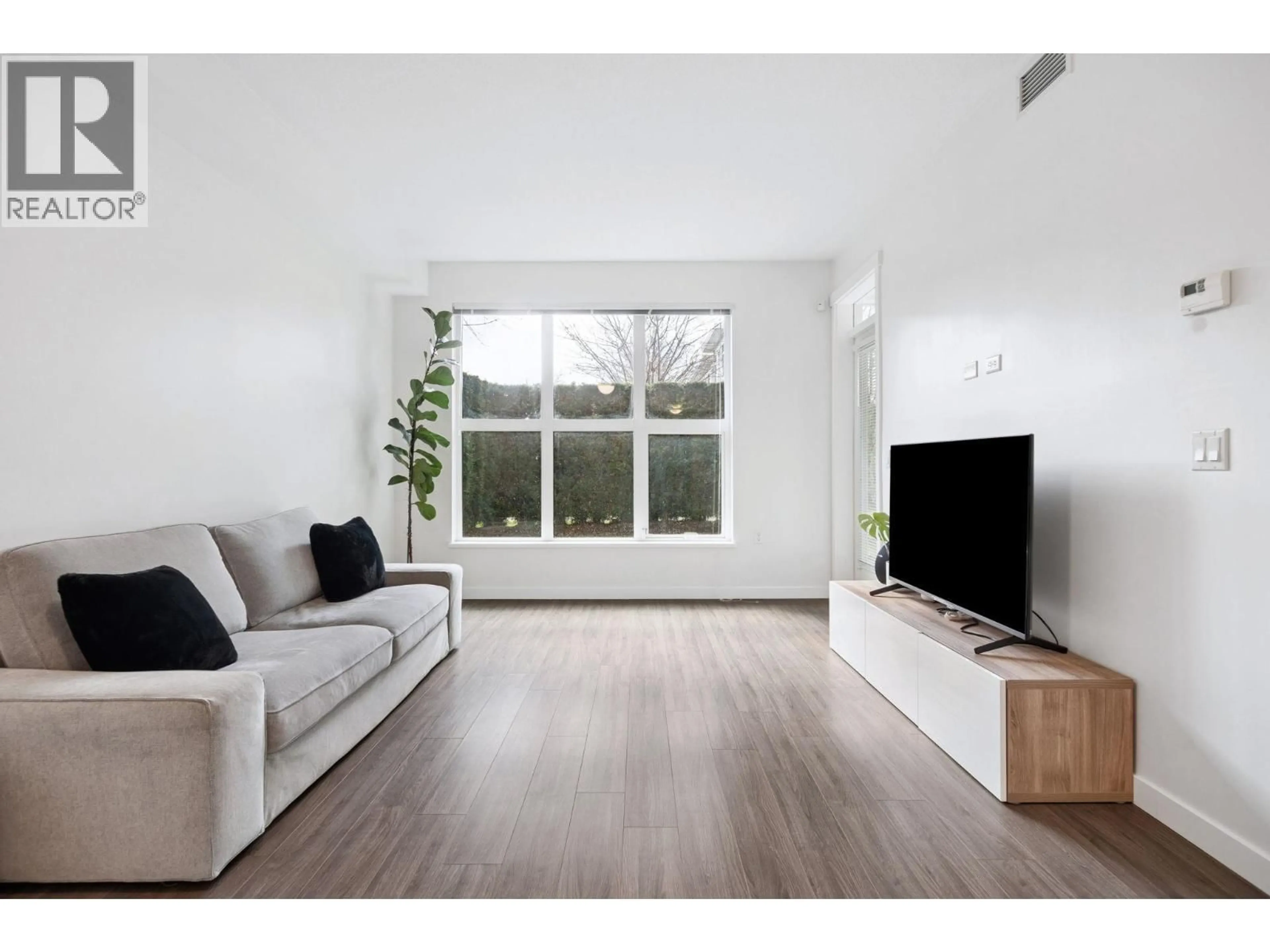 Living room with furniture, wood/laminate floor for 121 - 9500 TOMICKI AVENUE, Richmond British Columbia V6X0R9