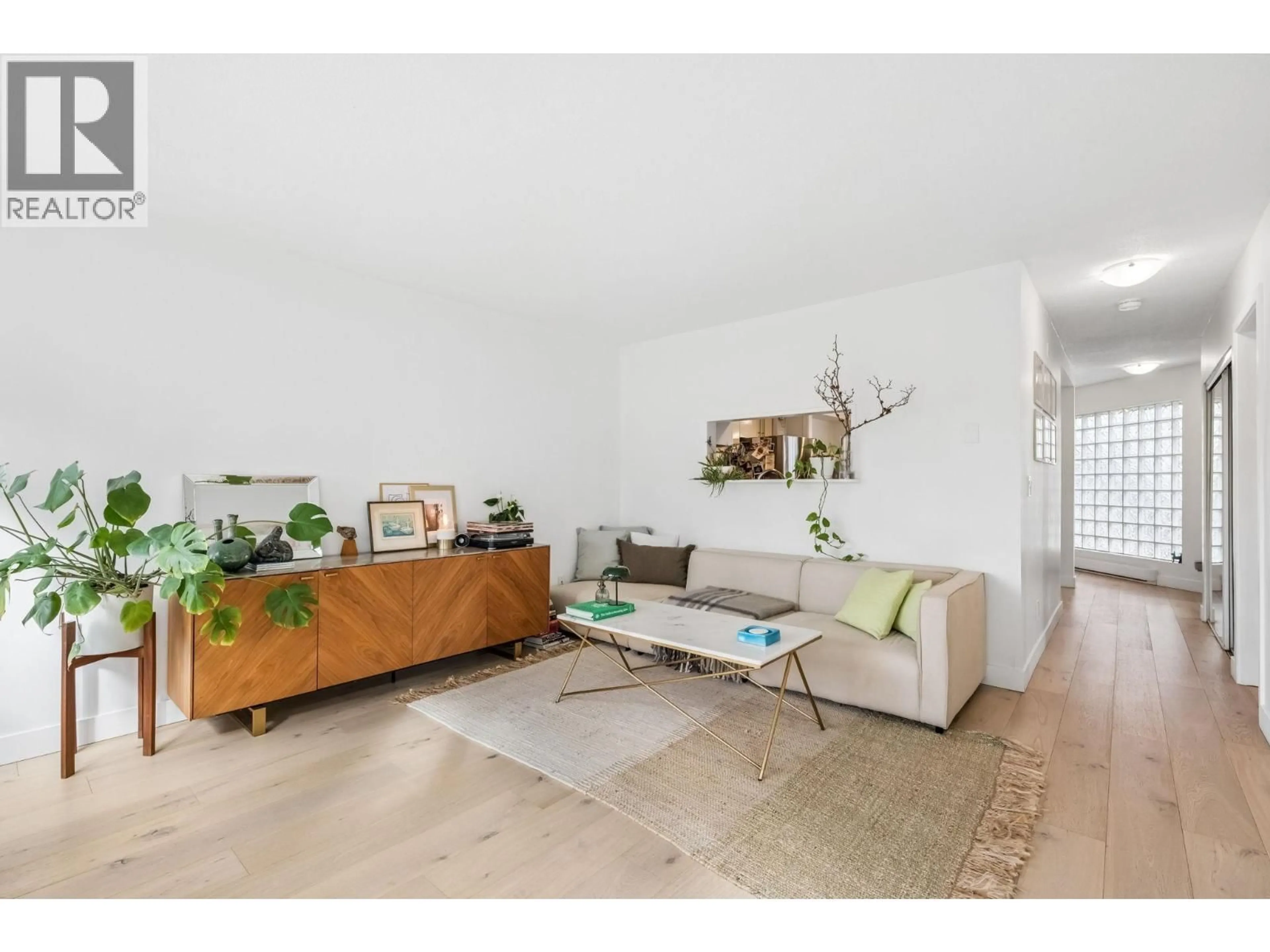 Living room with furniture, wood/laminate floor for 205 - 1330 GRAVELEY STREET, Vancouver British Columbia V5L3A2