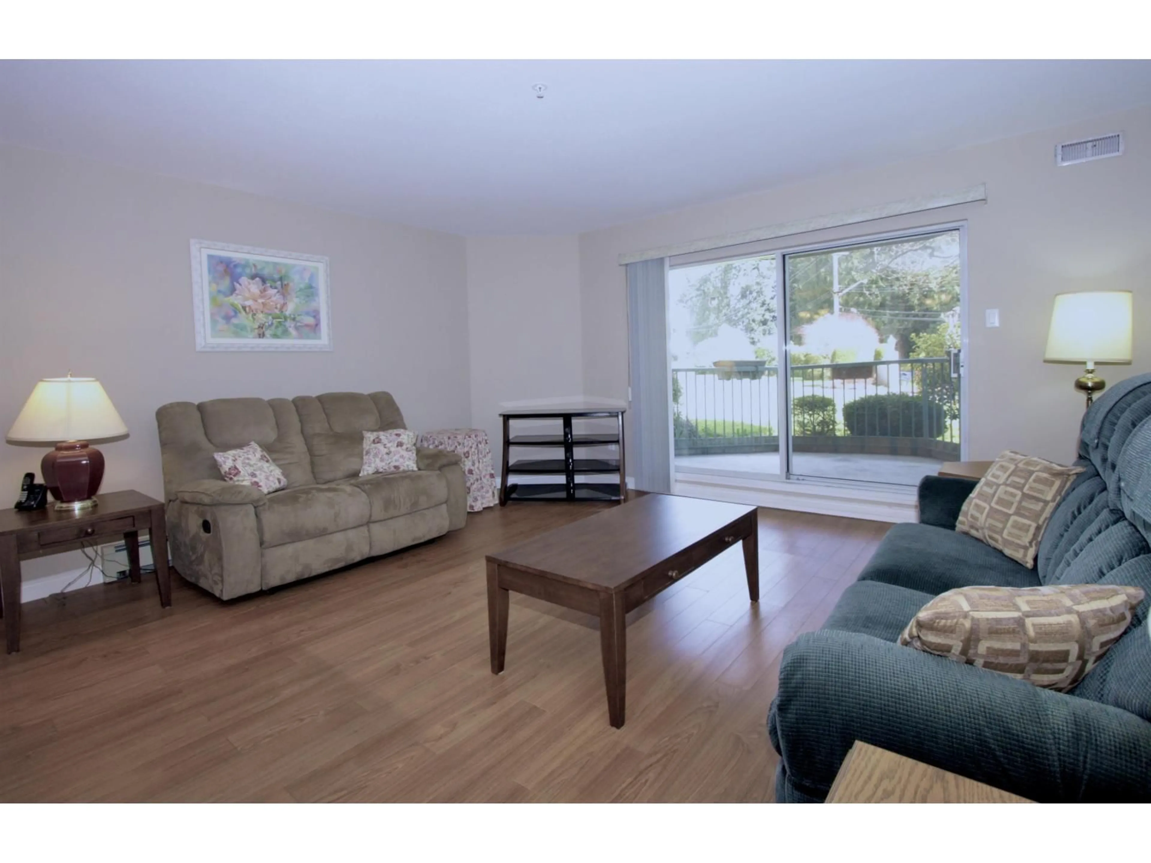 Living room with furniture, wood/laminate floor for 106 - 2451 GLADWIN ROAD, Abbotsford British Columbia V2T3N8