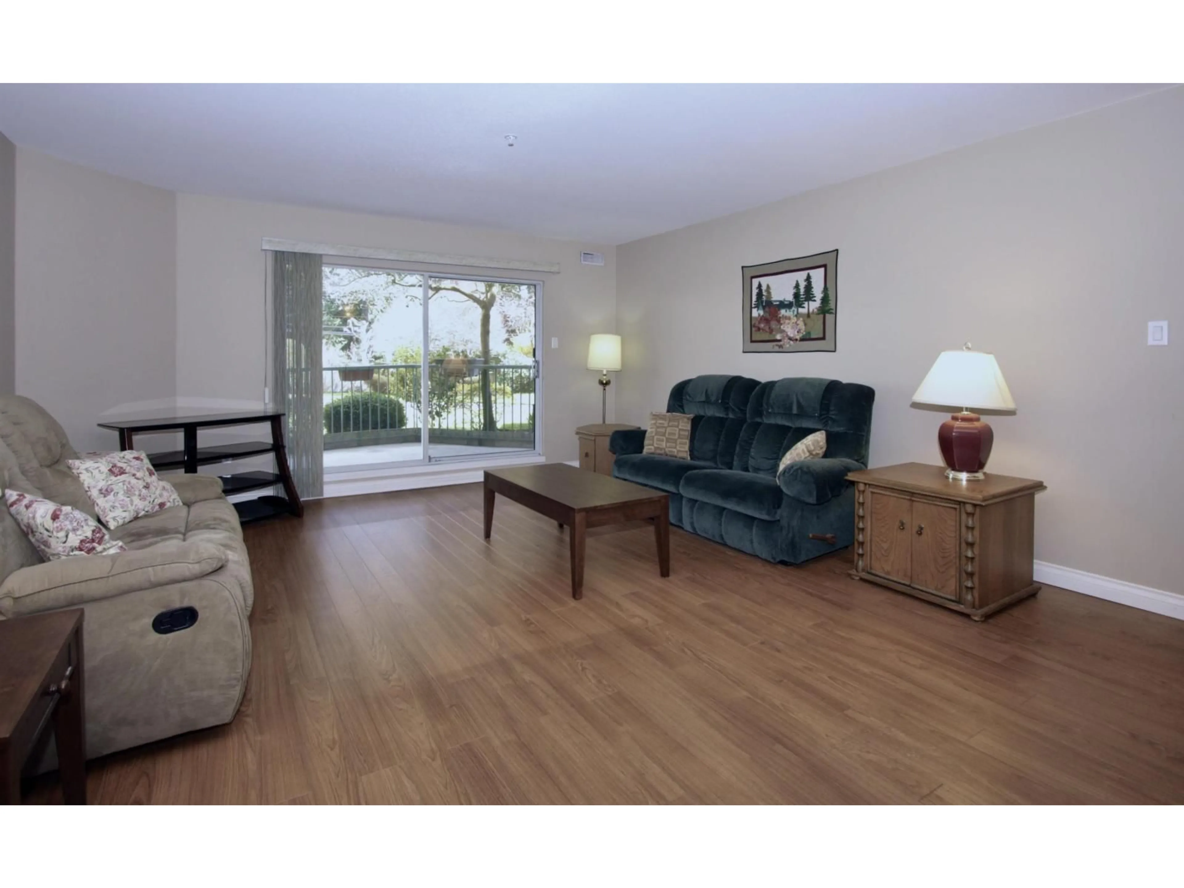 Living room with furniture, wood/laminate floor for 106 - 2451 GLADWIN ROAD, Abbotsford British Columbia V2T3N8