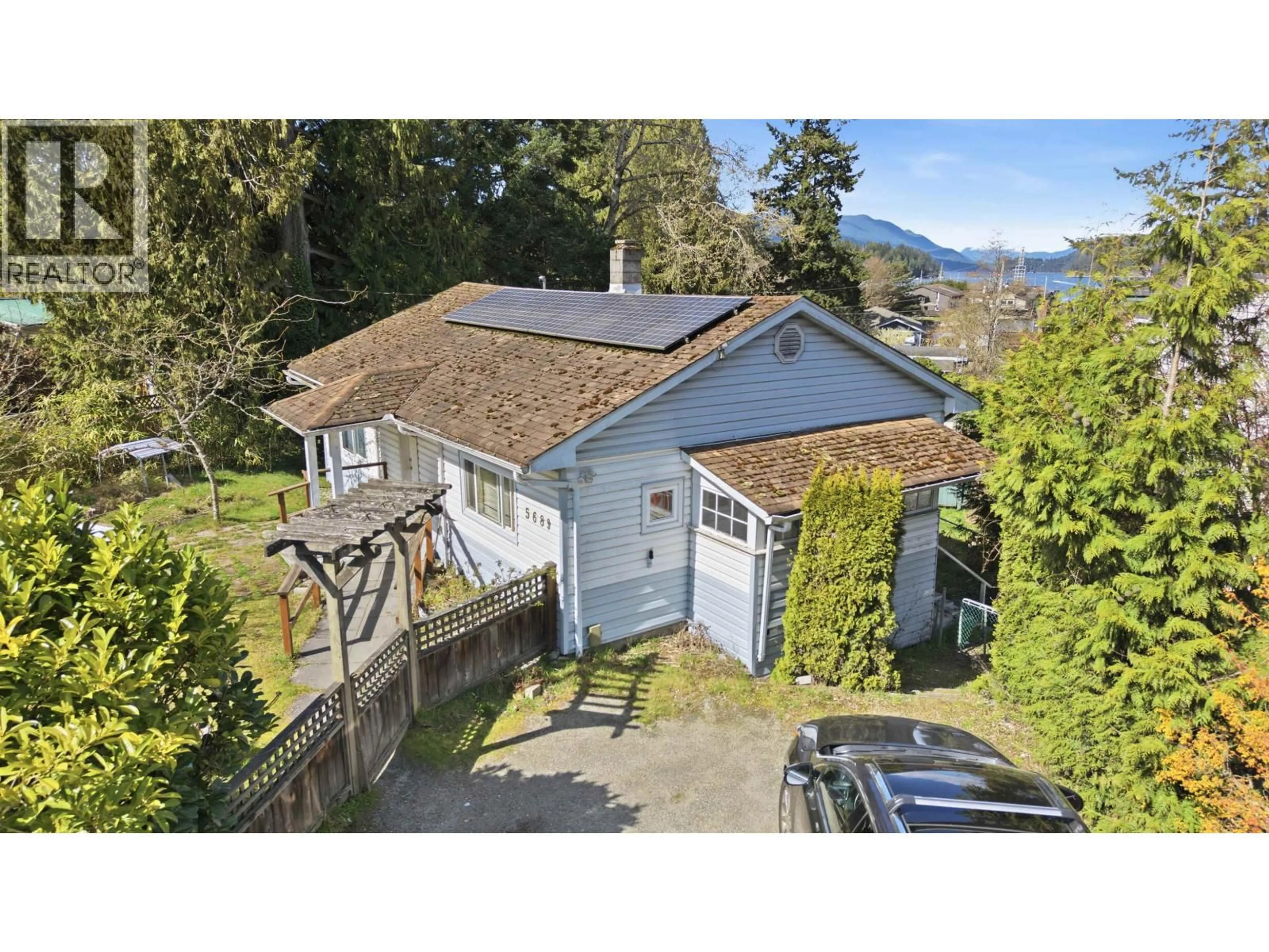 A pic from outside/outdoor area/front of a property/back of a property/a pic from drone, street for 5689 PORPOISE BAY ROAD, Sechelt British Columbia V0N1V0